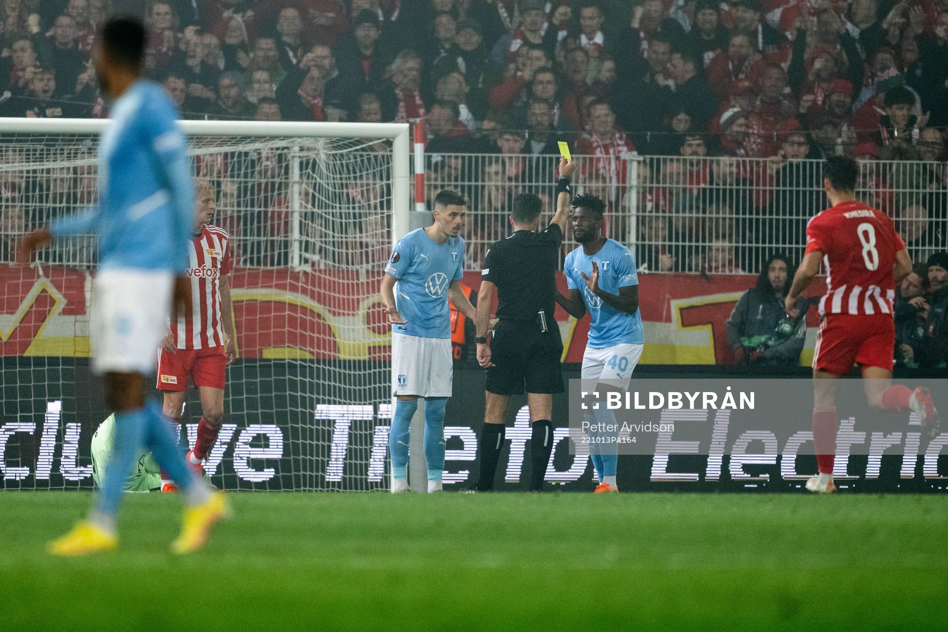 Emmanuel Lomotey of Malmö FF receives a yellow card from