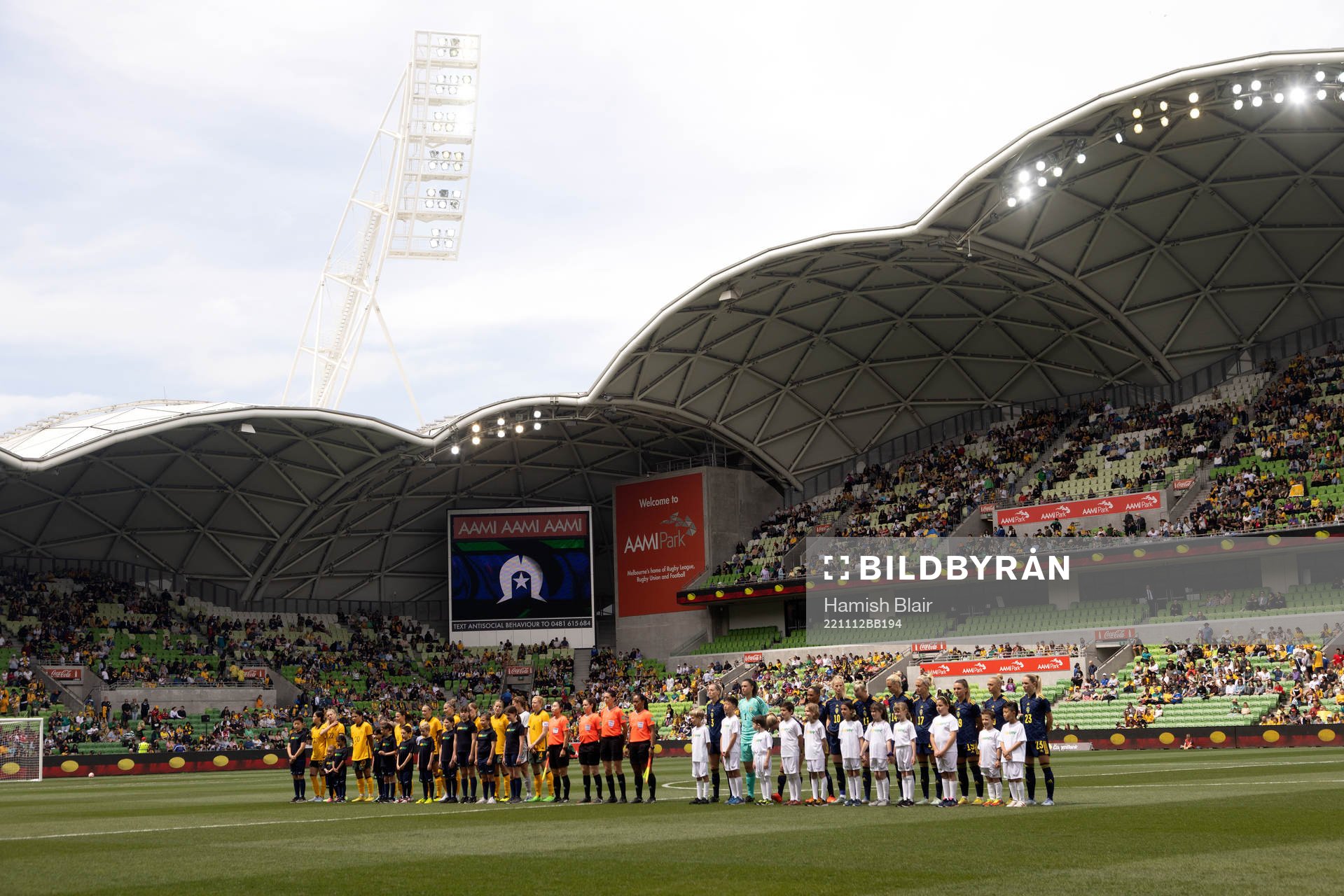 Both teams line up for the national anthems