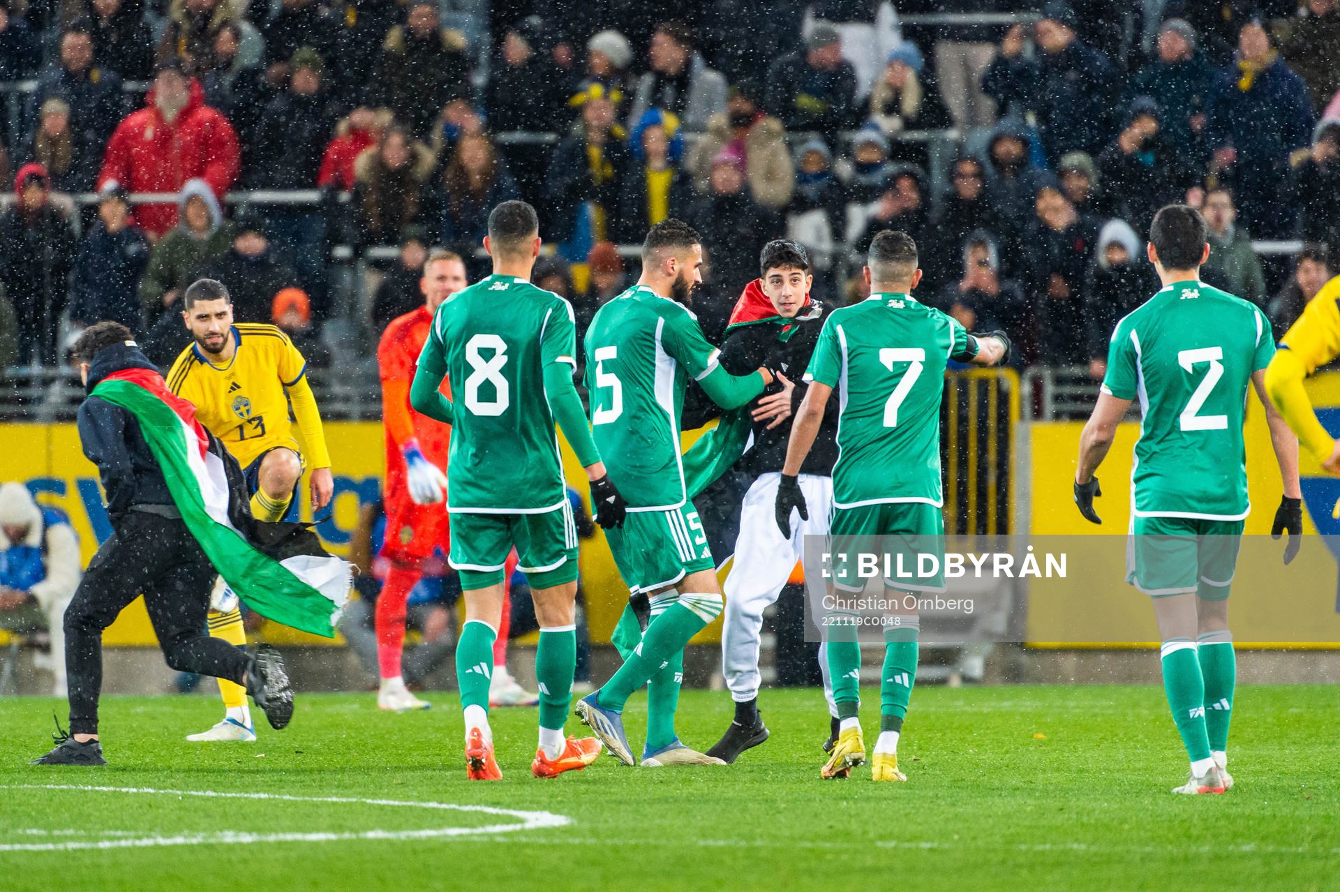 Ahmed Touba of Algeria holds a pitch invader during the international friendly football match between Sweden and Algeria on November 19, 2022 in Malmö.