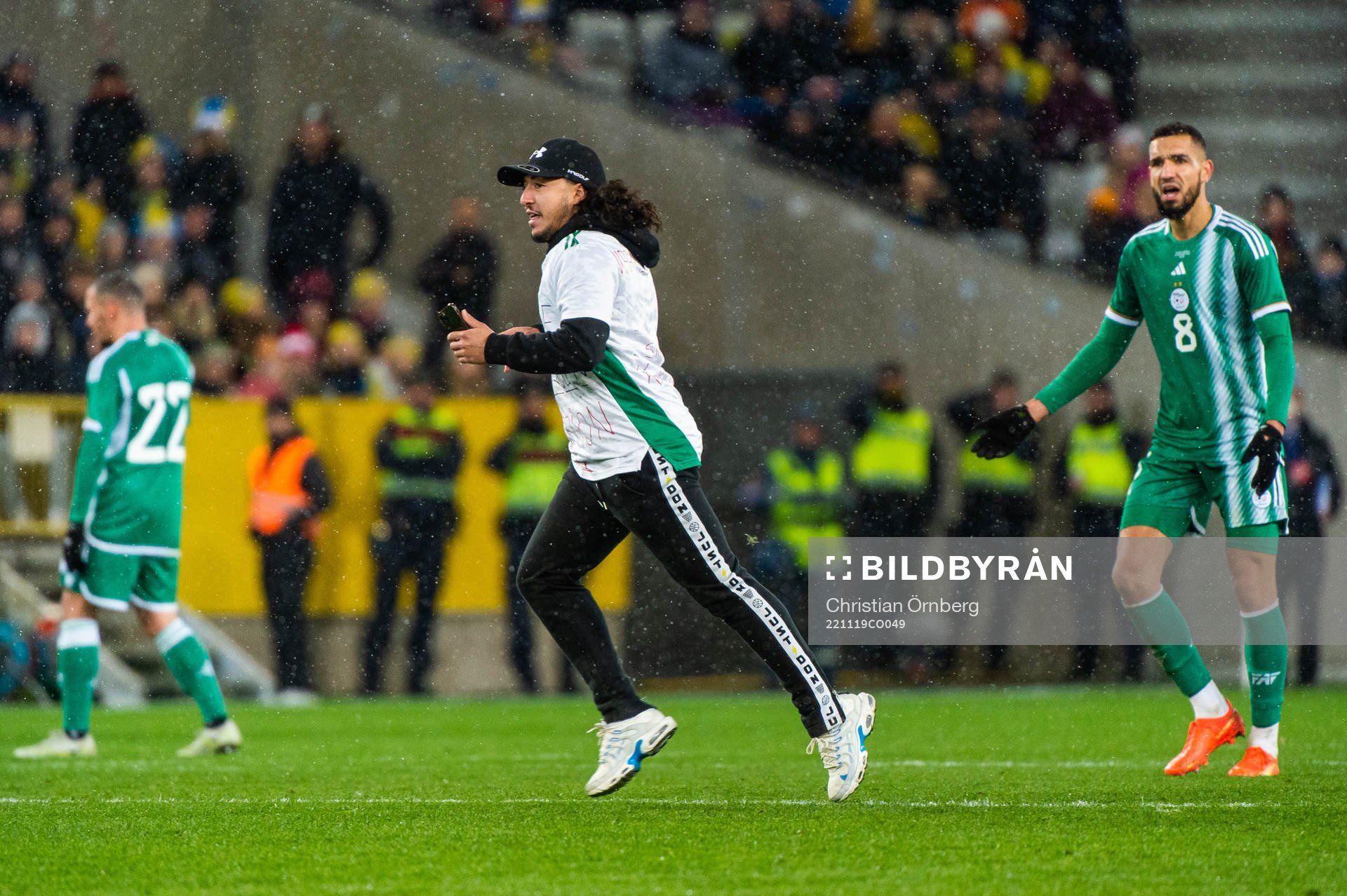A pitch invader next to Nabil Bentaleb of Algeria during the international friendly football match between Sweden and Algeria on November 19, 2022 in Malmö.