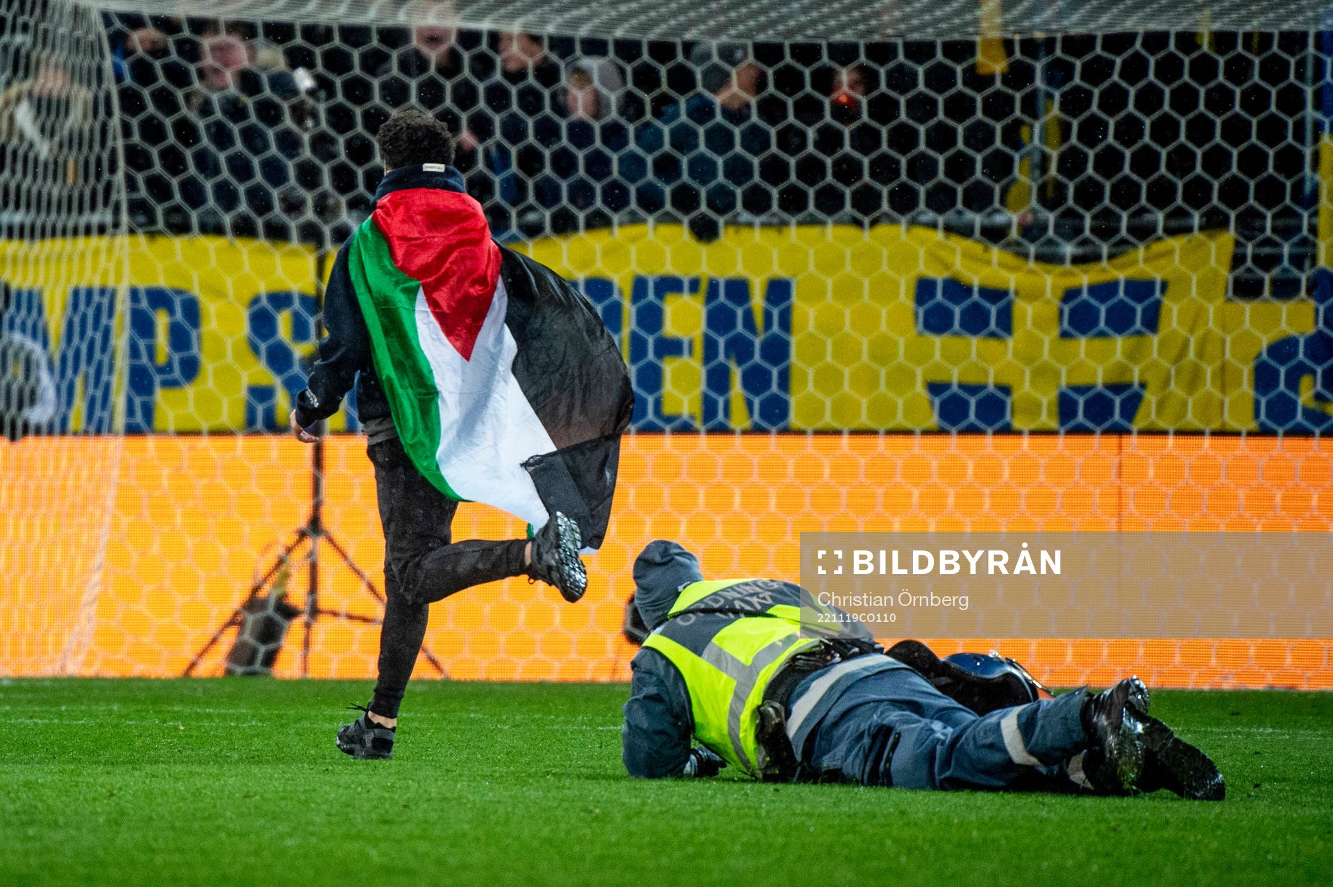 Security personel chase a pitch invader