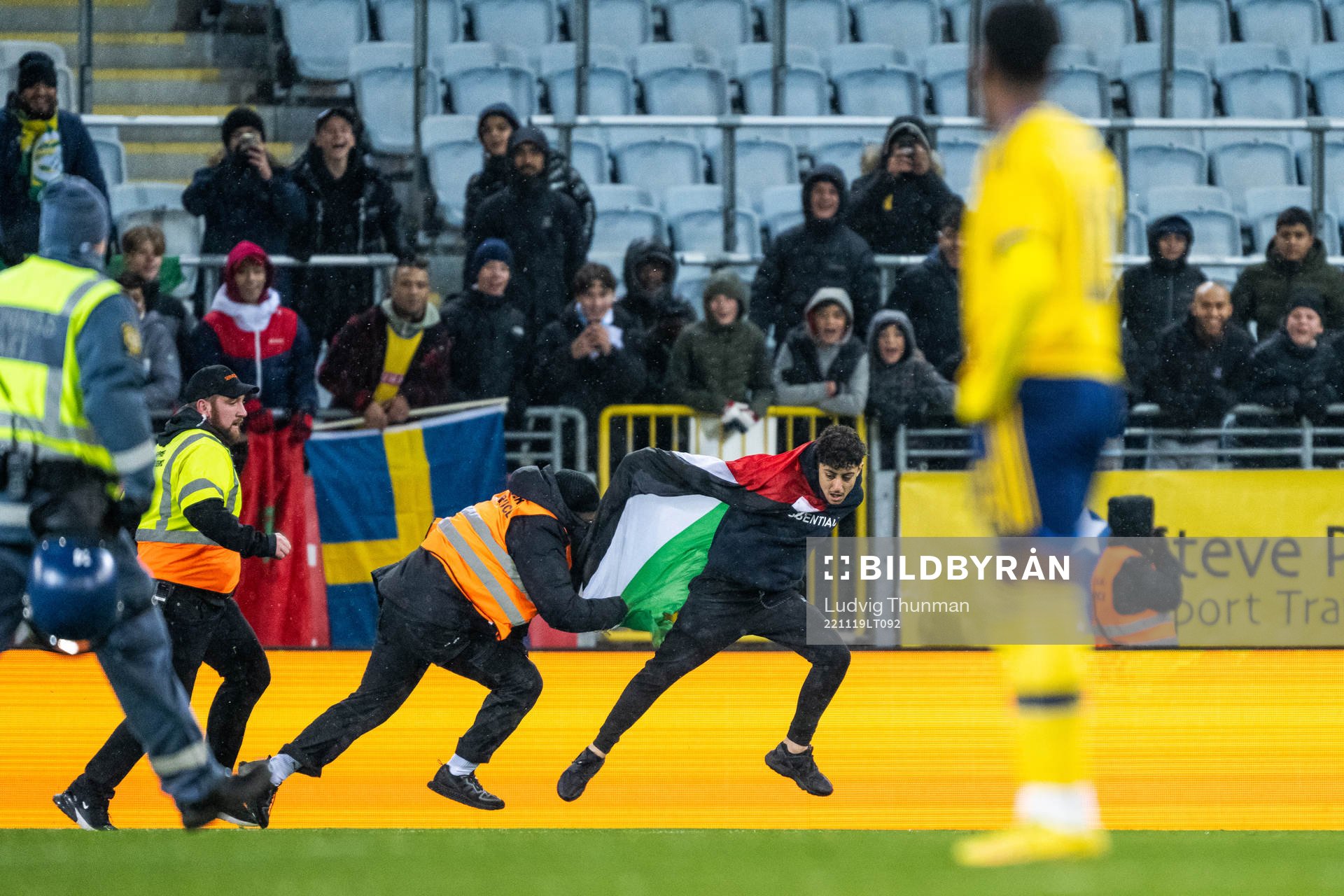 Security personell chase a pitch invader