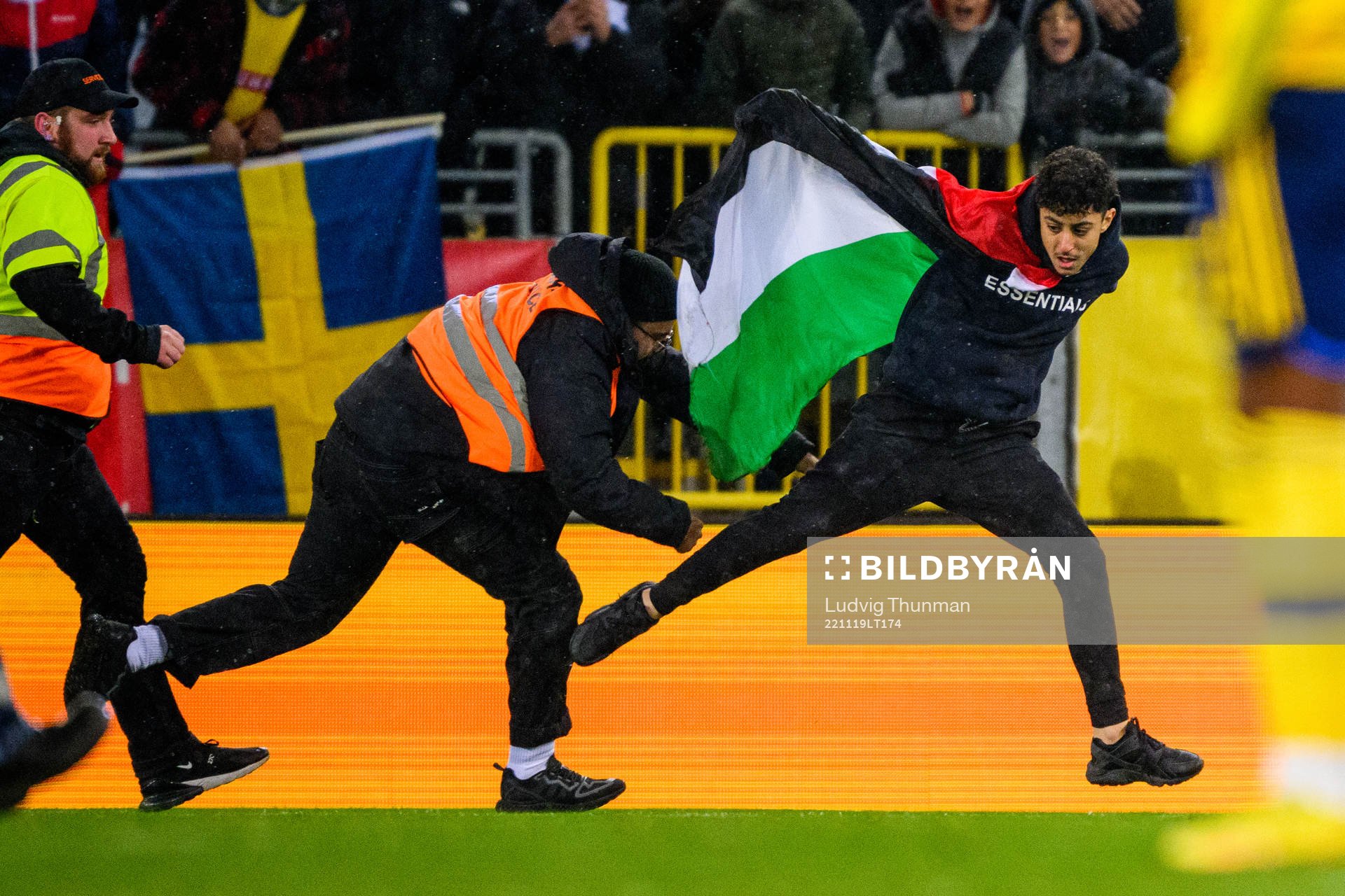 Security personal chases a pitch invader
