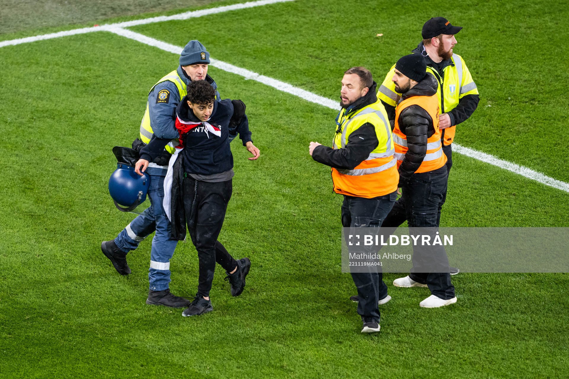 Security personell hold a pitch invader during the international friendly football match between Sweden and Algeria on November 19, 2022 in Malmö.