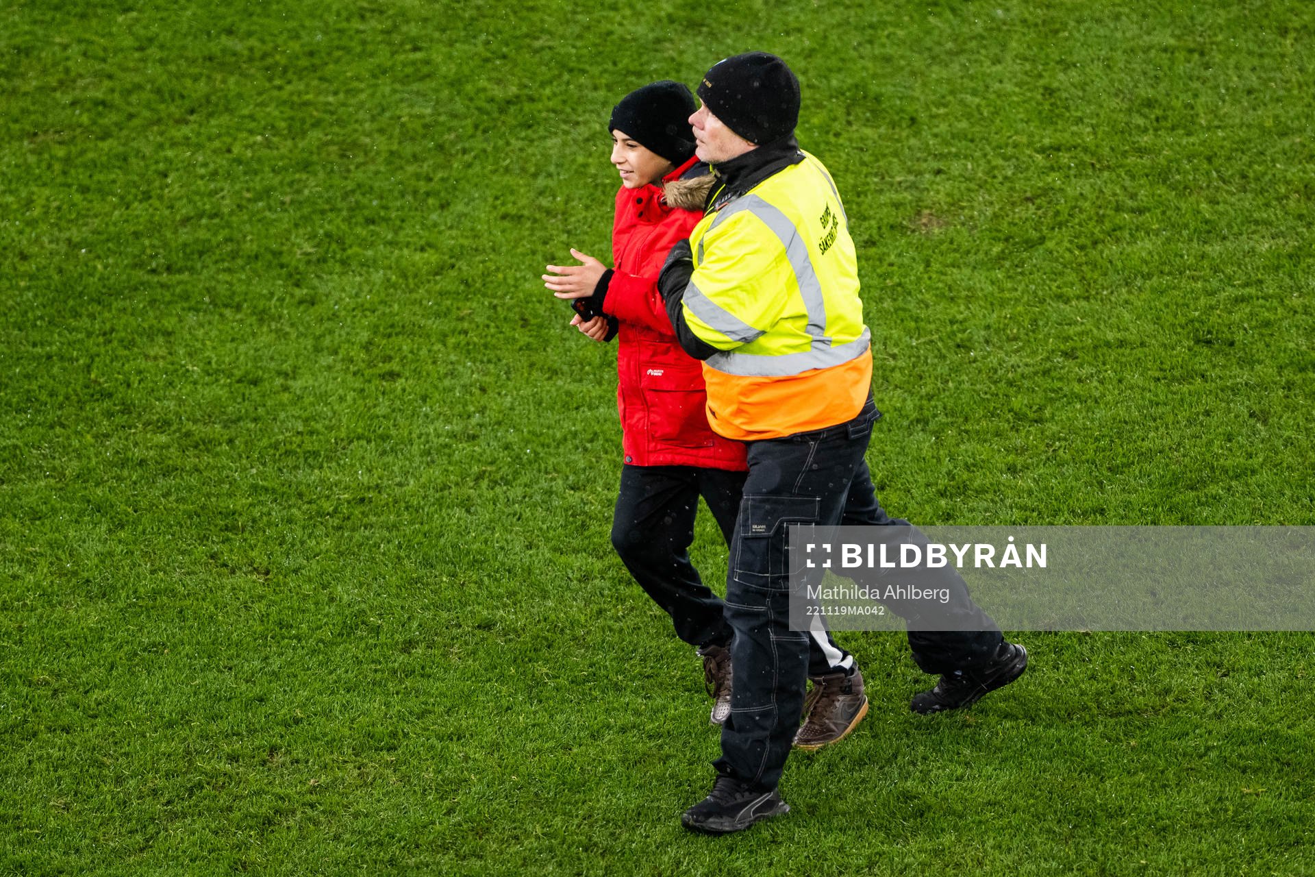 Security personell hold a pitch invader during the international friendly football match between Sweden and Algeria on November 19, 2022 in Malmö.