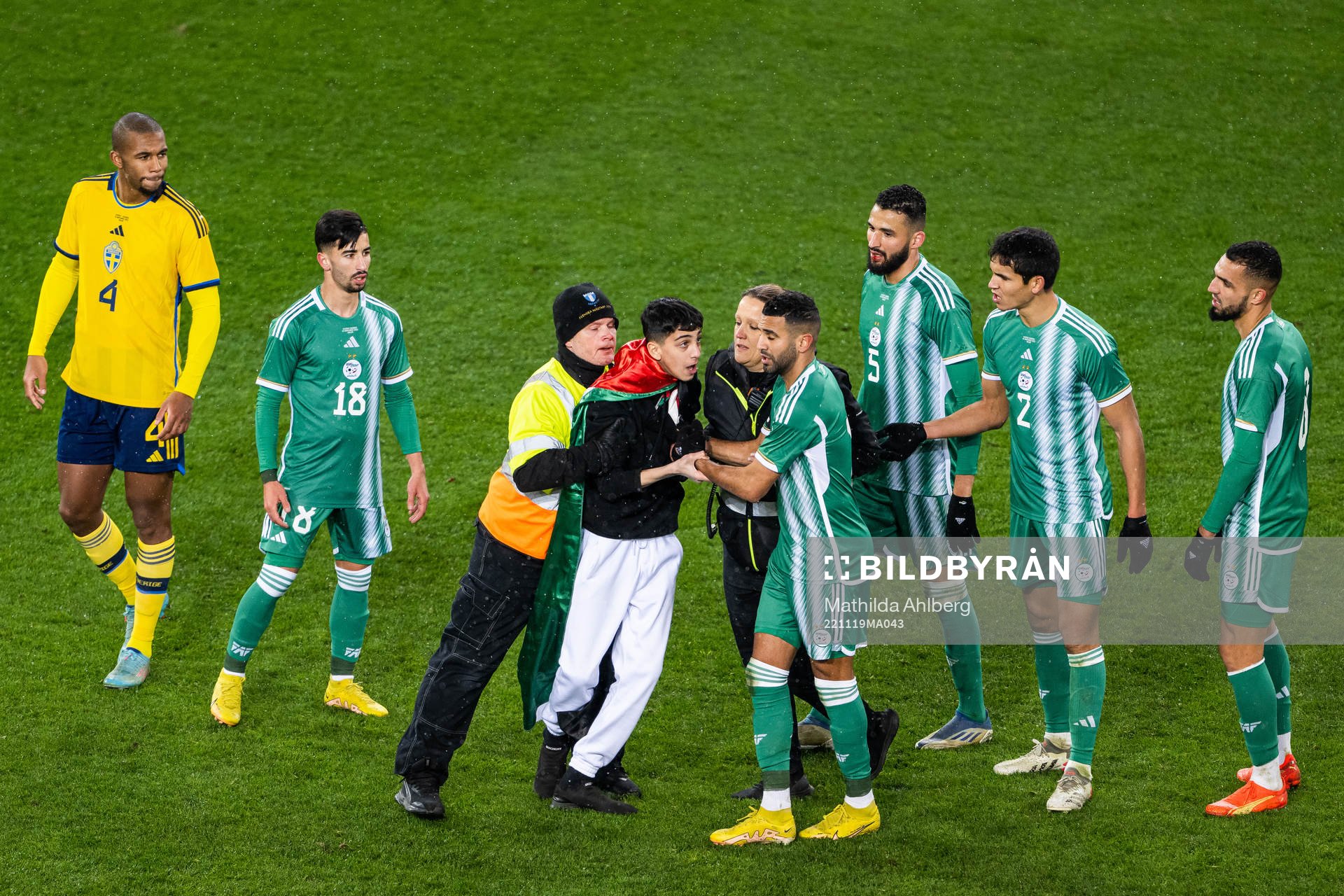 Security personell hold a pitch invader during the international friendly football match between Sweden and Algeria on November 19, 2022 in Malmö. 