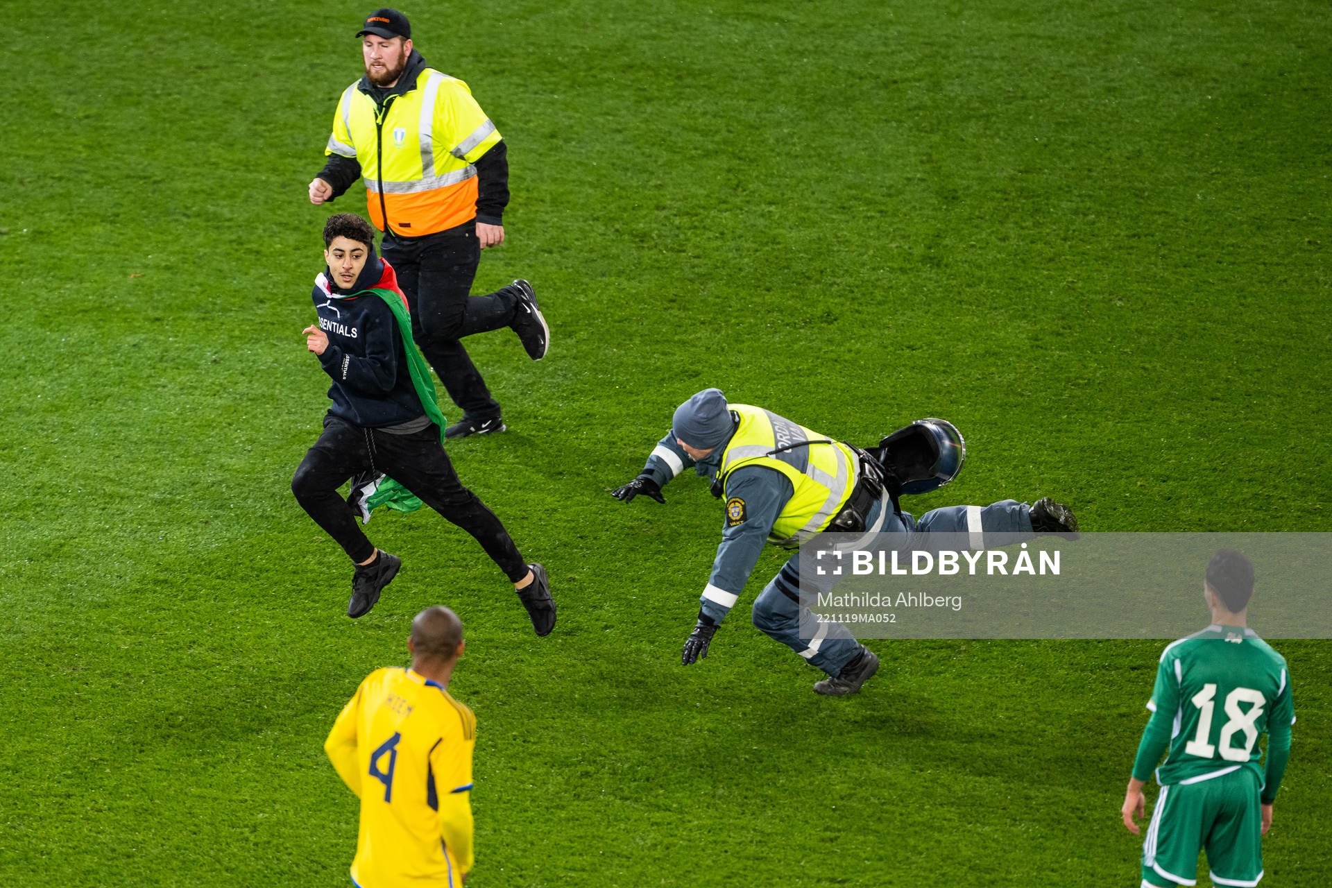 Security personel chase a pitch invader during the international friendly football match between Sweden and Algeria on November 19, 2022 in Malmö.