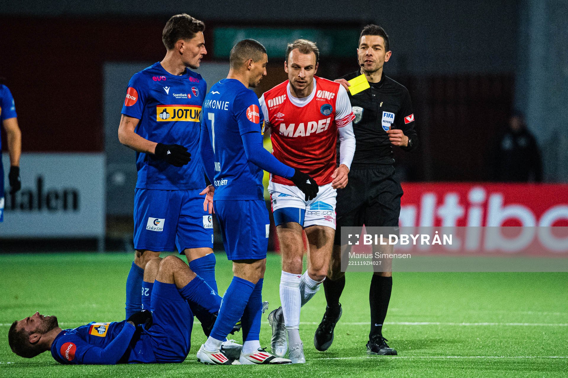 Lars Christian Krogh Gerson of Kongsvinger after receiving a yellow card by Tore Hansen, referee, during the Eliteserien playoff football match between Kongsvinger and Sandefjord on November 19, 2022 in Kongsvinger.
