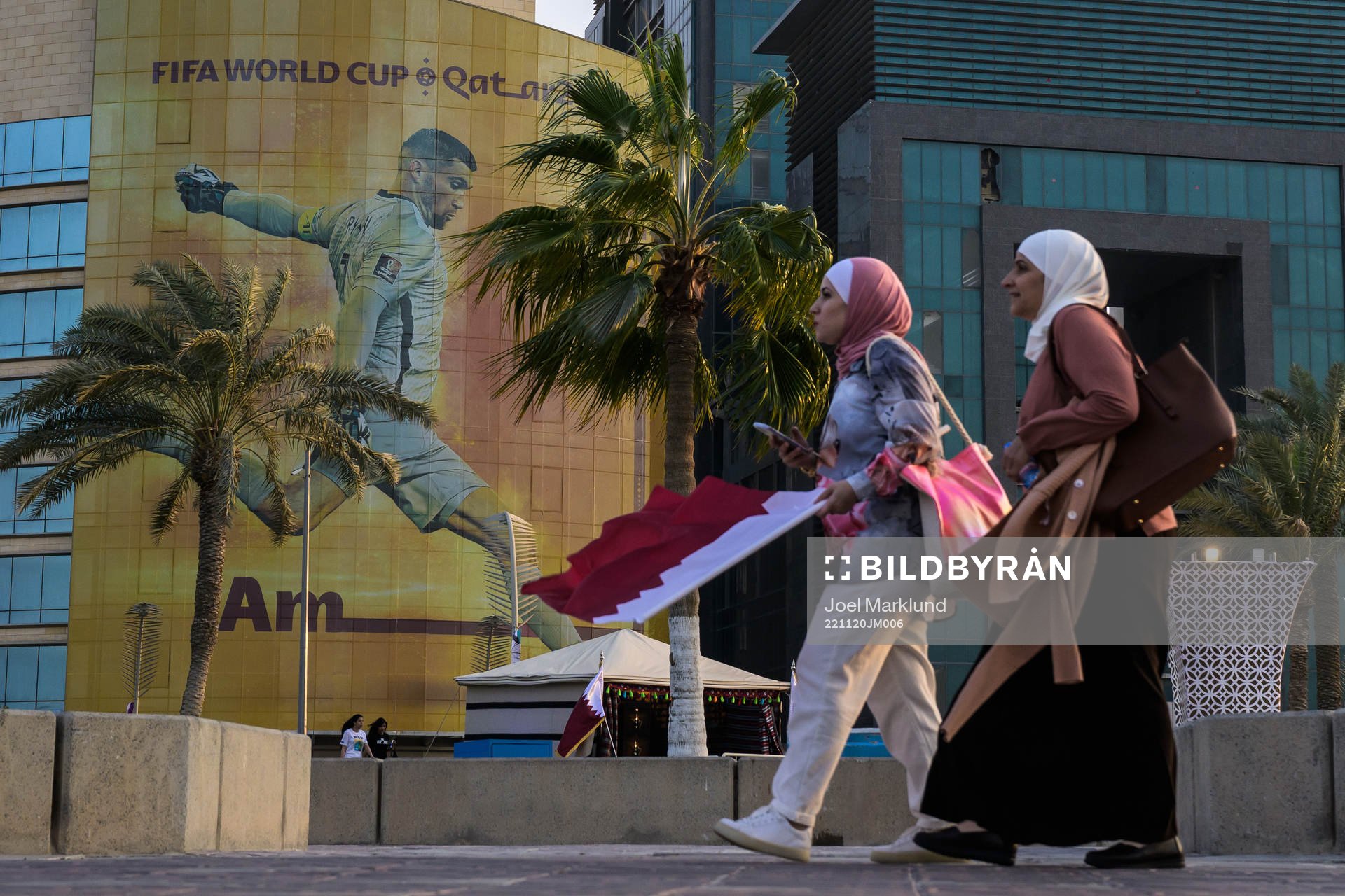 Women walk past advertising