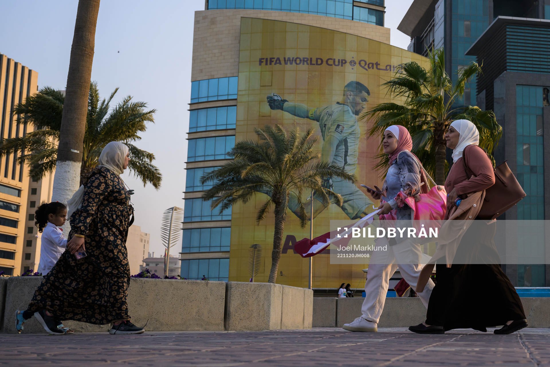 Women walk past advertising