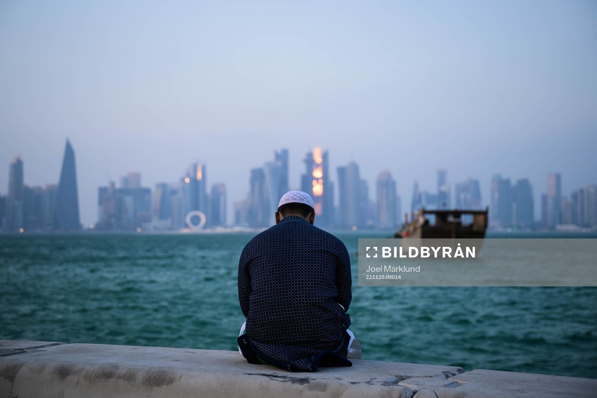 A man sits at the Corniche Promenade