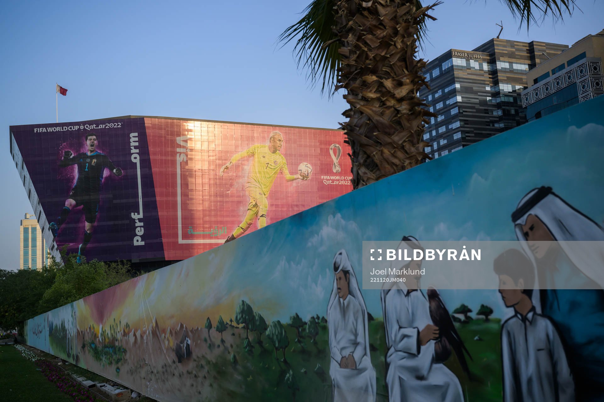 A traditional mural in front of advertising