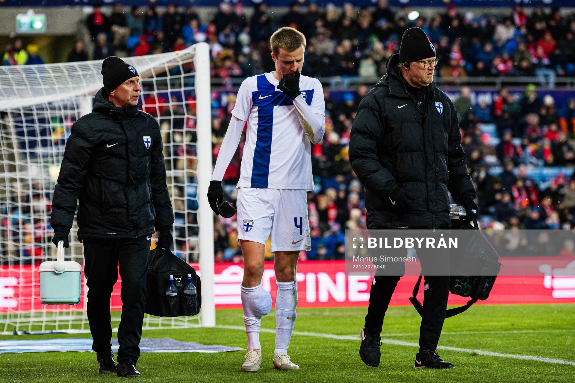 Robert Ivanov of Finland leaves the pitch with an injury