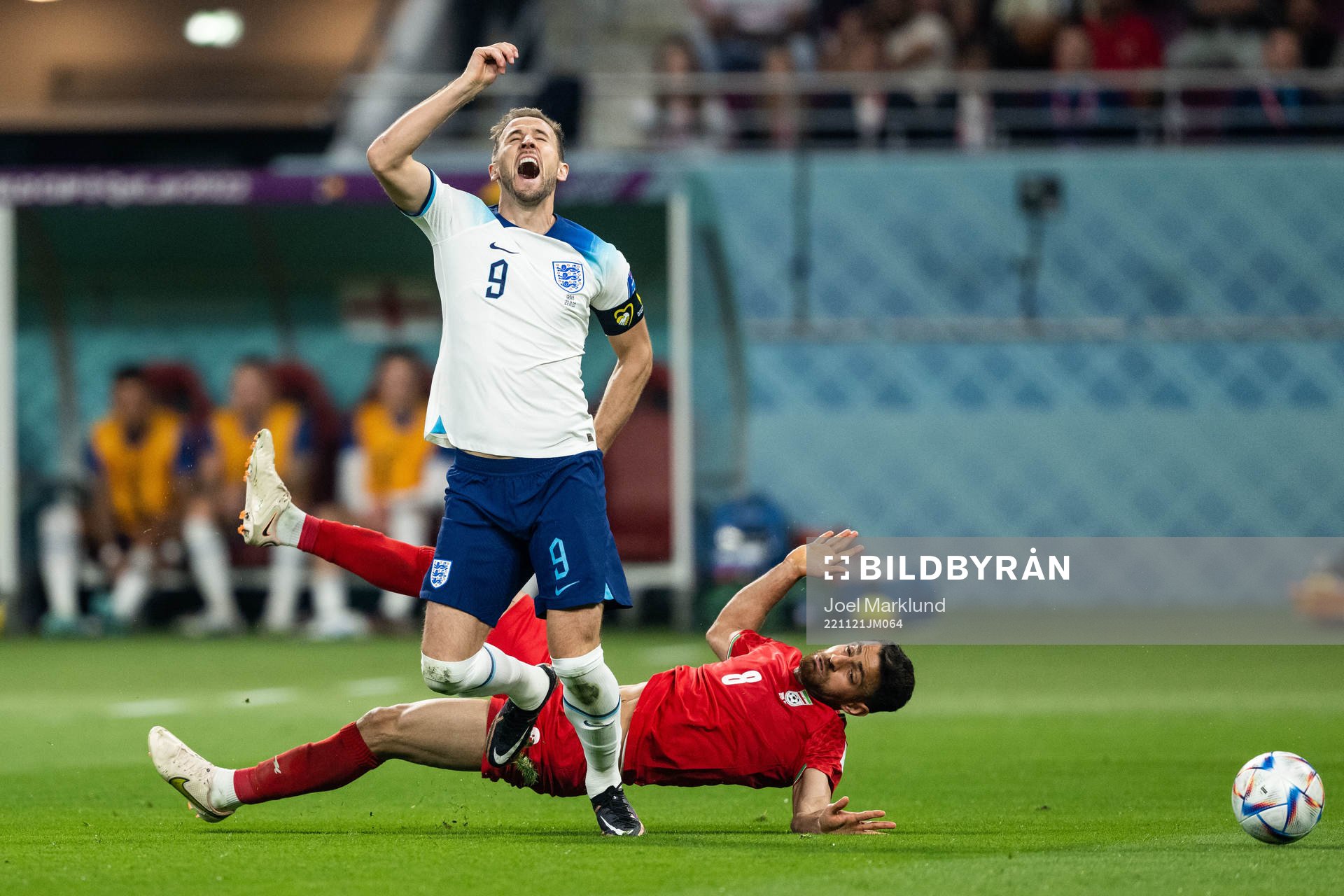 Harry Kane of England and Morteza Pouraliganji of Iran