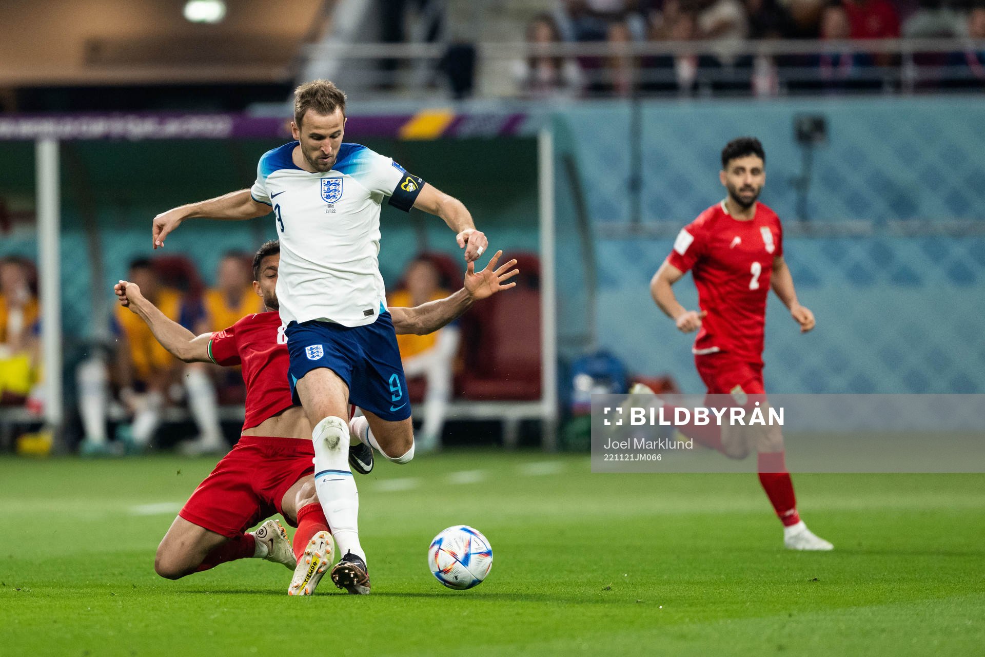 Harry Kane of England and Morteza Pouraliganji of Iran