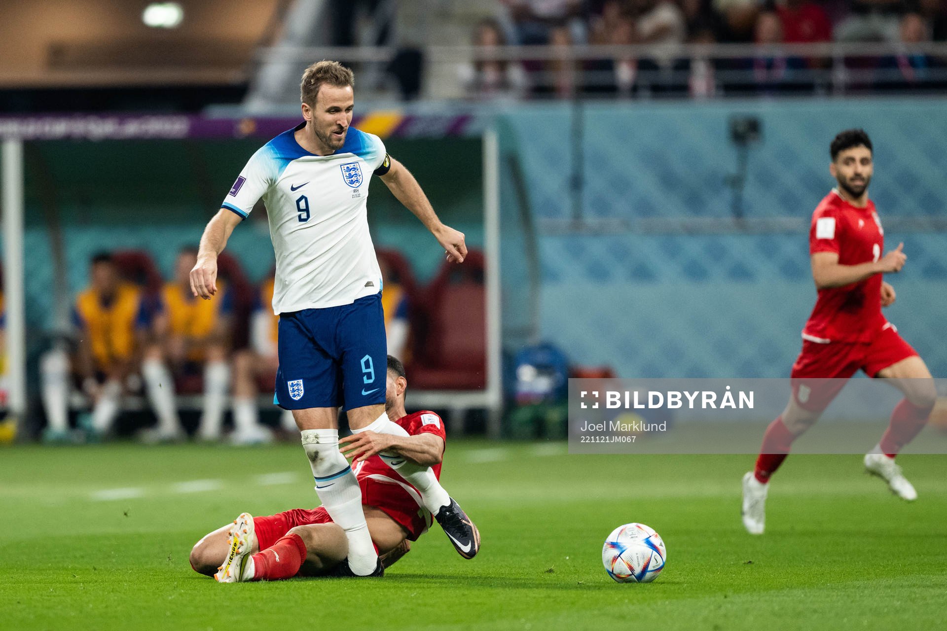 Harry Kane of England and Morteza Pouraliganji of Iran