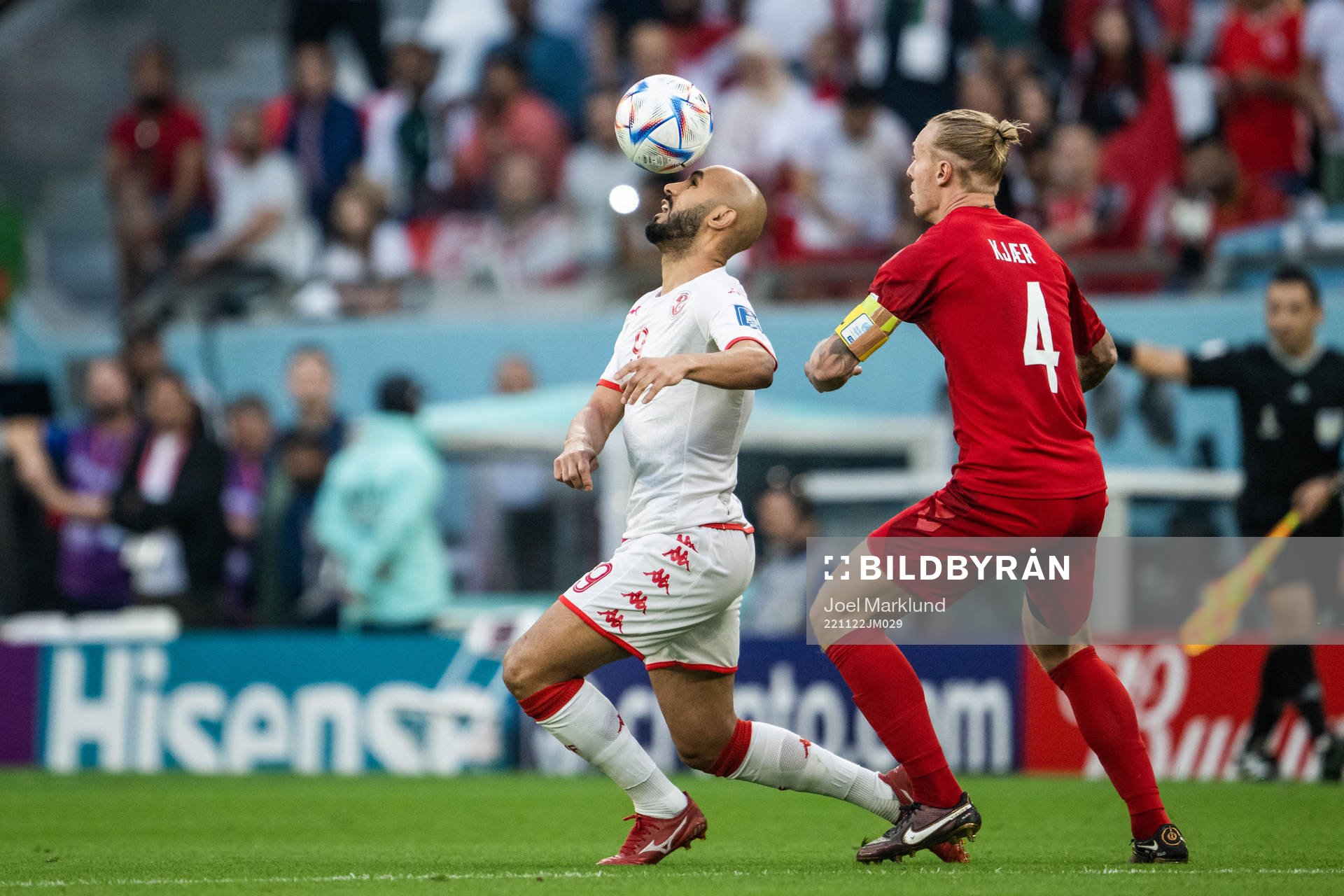 Issam Jebali of Tunisia and Simon Kjær of Denmark
