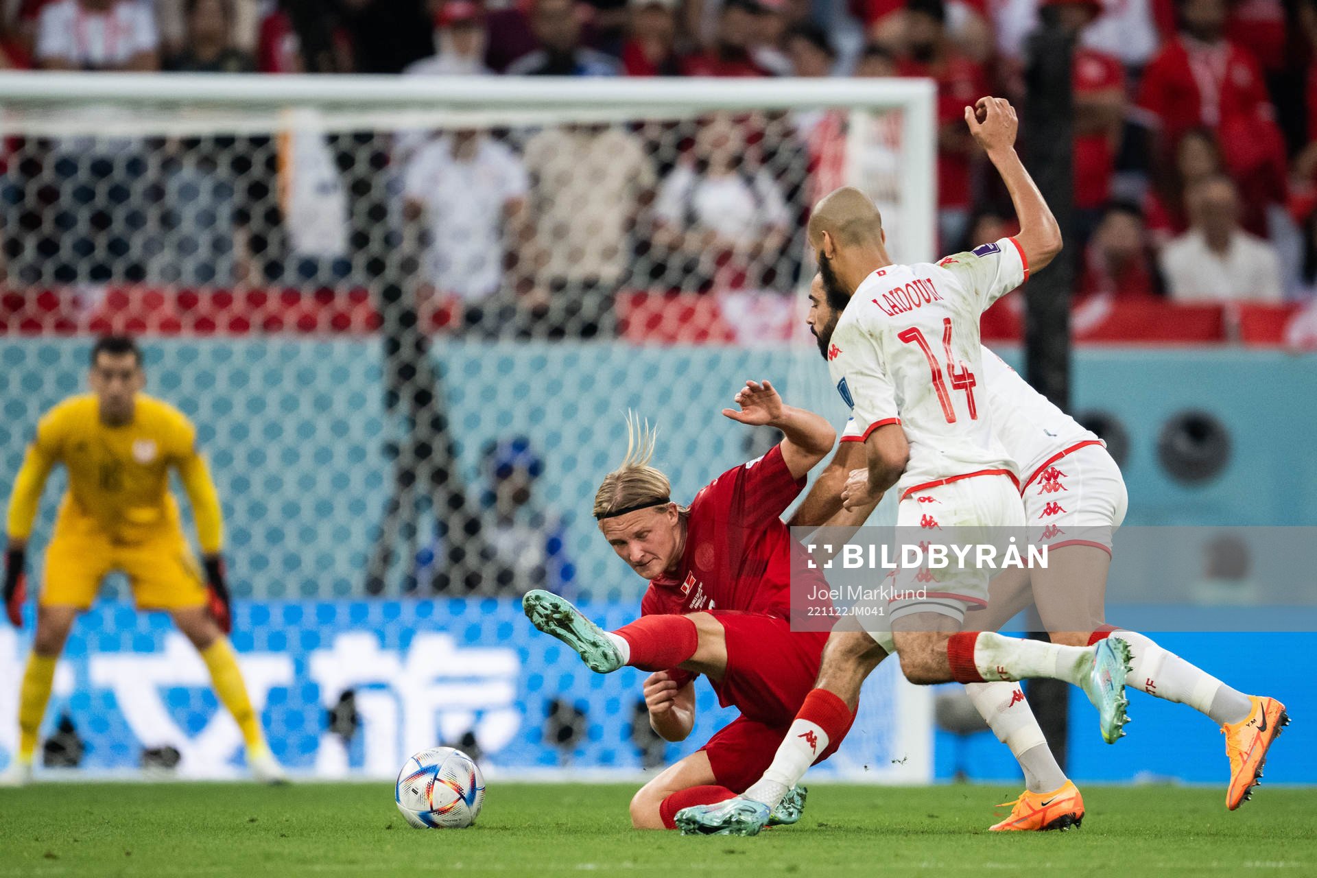 Kasper Dolberg of Denmark against Yassine Meriah and Aissa Laidouni of Tunisia during the FIFA World Cup 2022 football match between Denmark and Tunisia on November 22, 2022 in Doha.