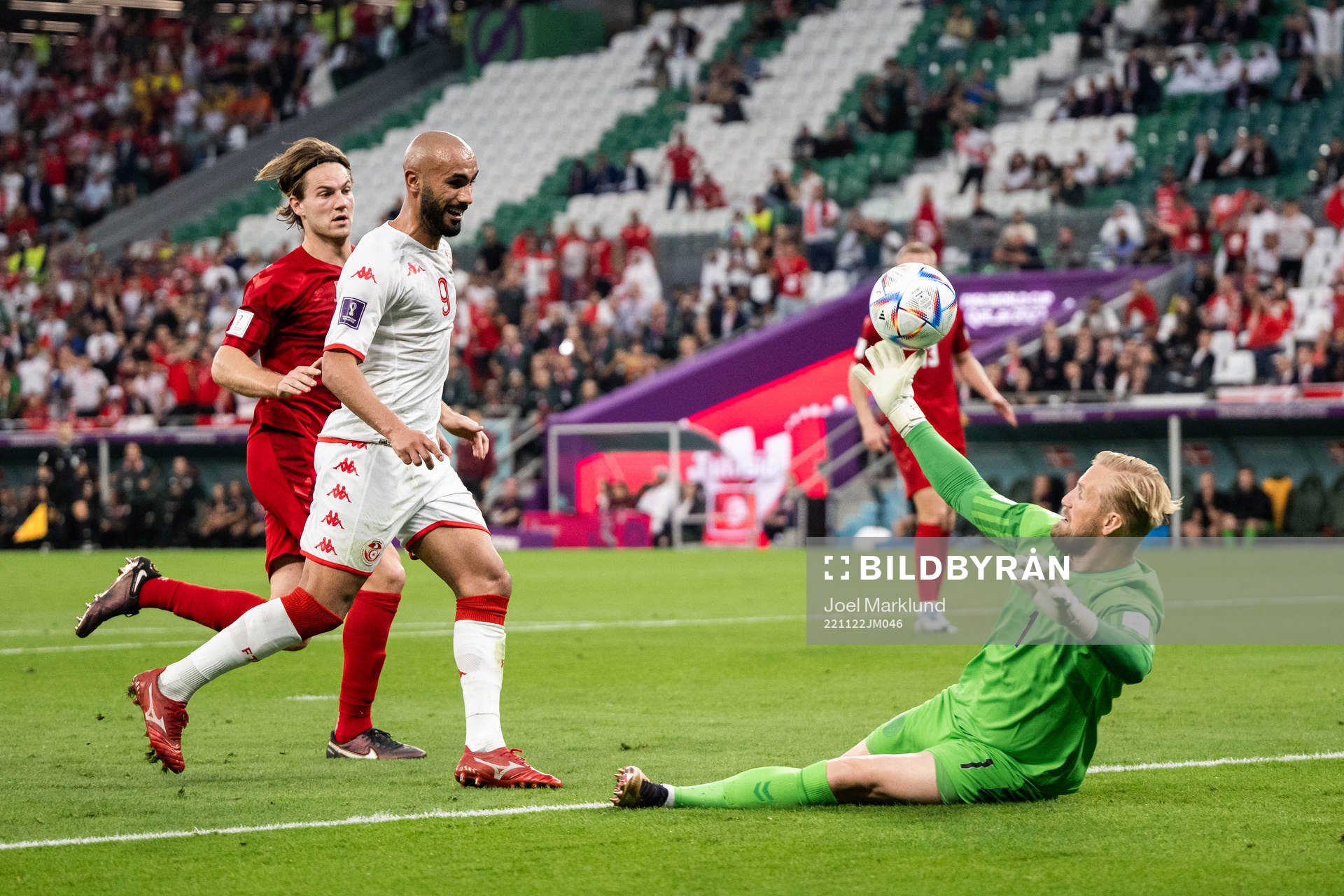 Issam Jebali of Tunisia and goalkeeper Kasper Schmeichel of Denmark during the FIFA World Cup 2022 football match between Denmark and Tunisia on November 22, 2022 in Doha.