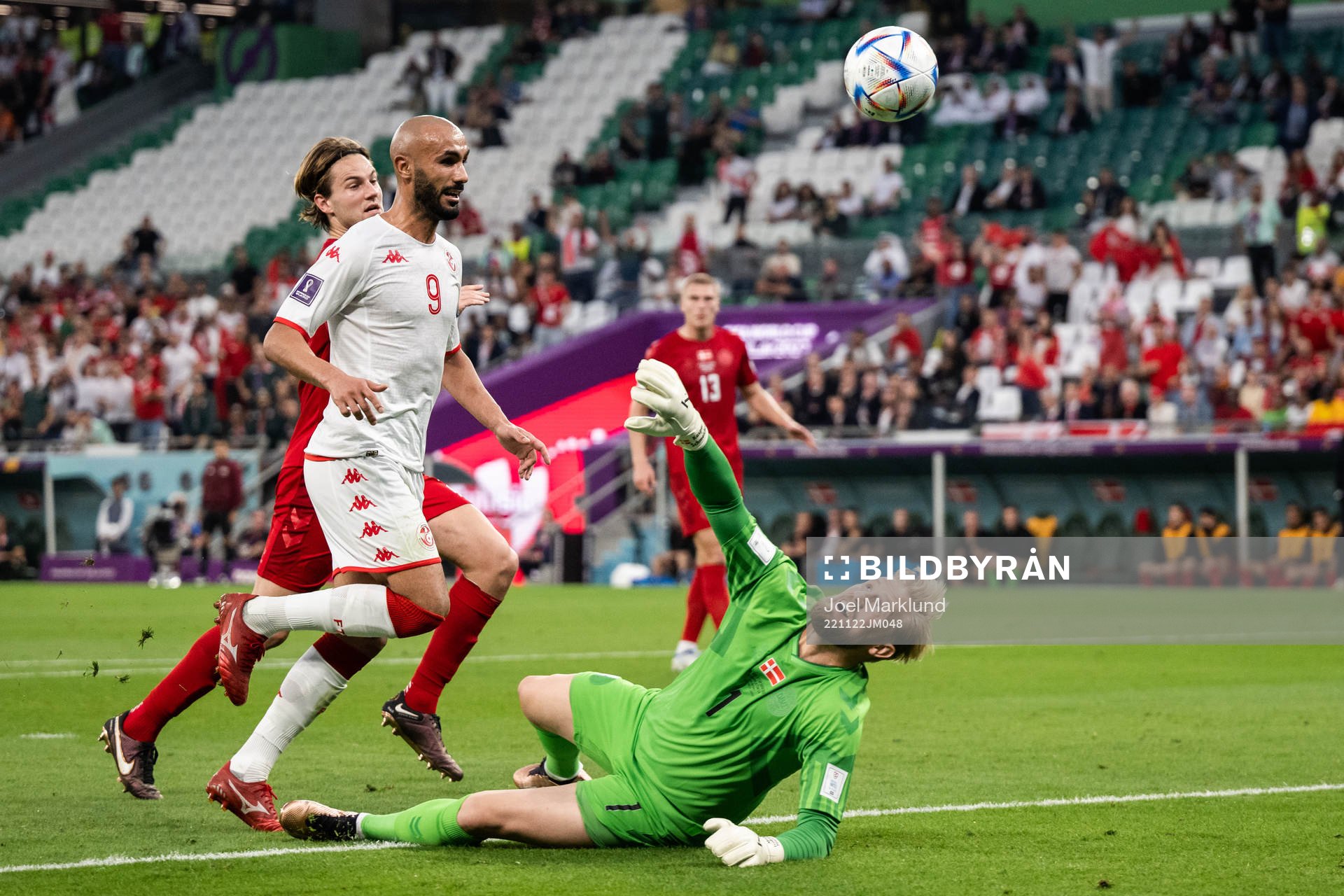 Issam Jebali of Tunisia and goalkeeper Kasper Schmeichel of Denmark during the FIFA World Cup 2022 football match between Denmark and Tunisia on November 22, 2022 in Doha.
