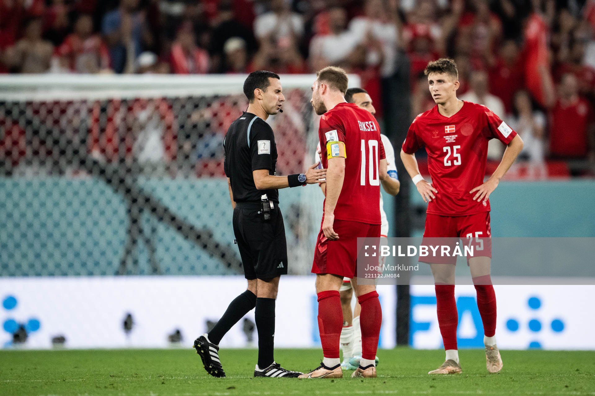 referee Cesar Ramos and Christian Eriksen of Denmark
