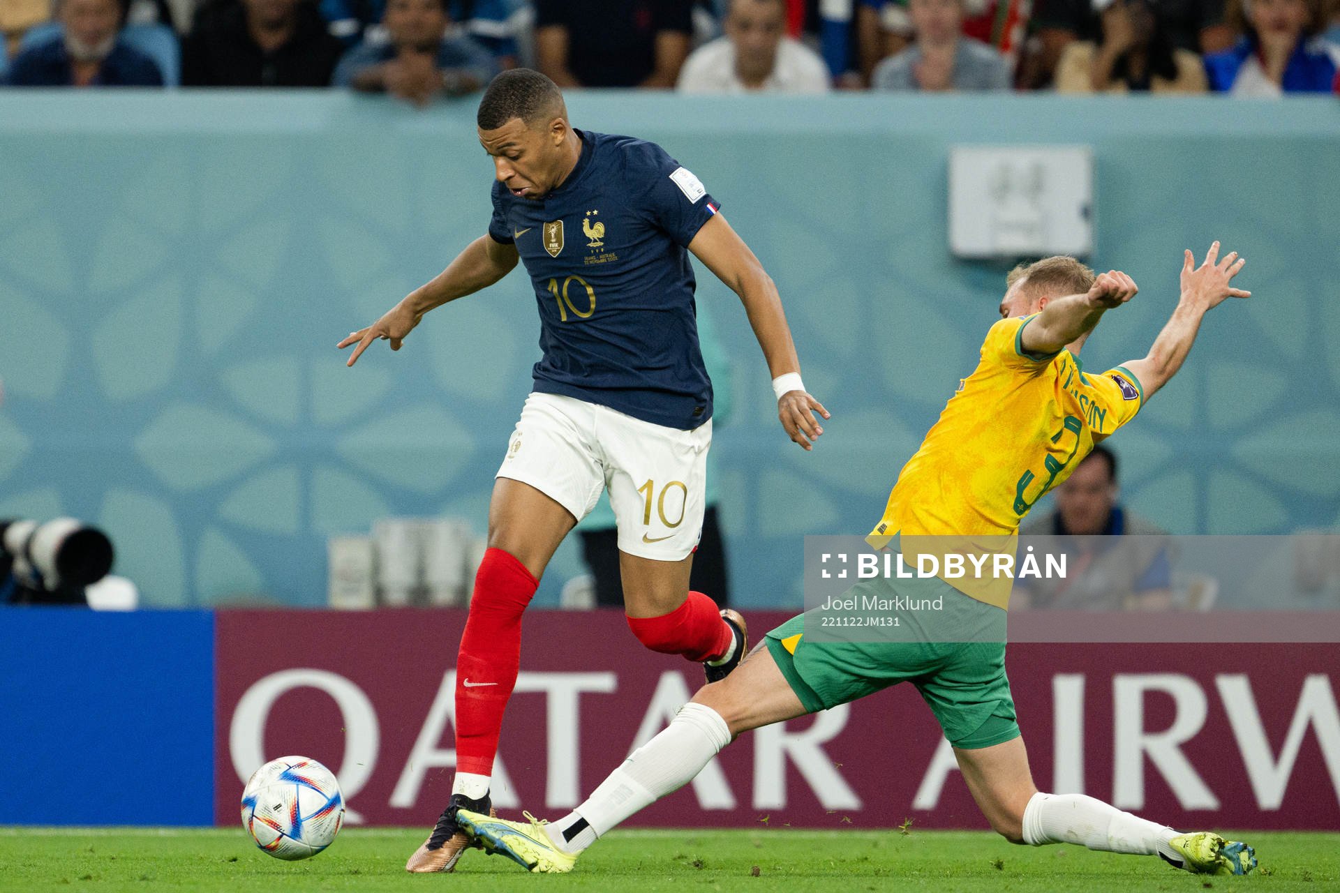 Kylian Mbappe of France and Nathaniel Atkinson of Australia
