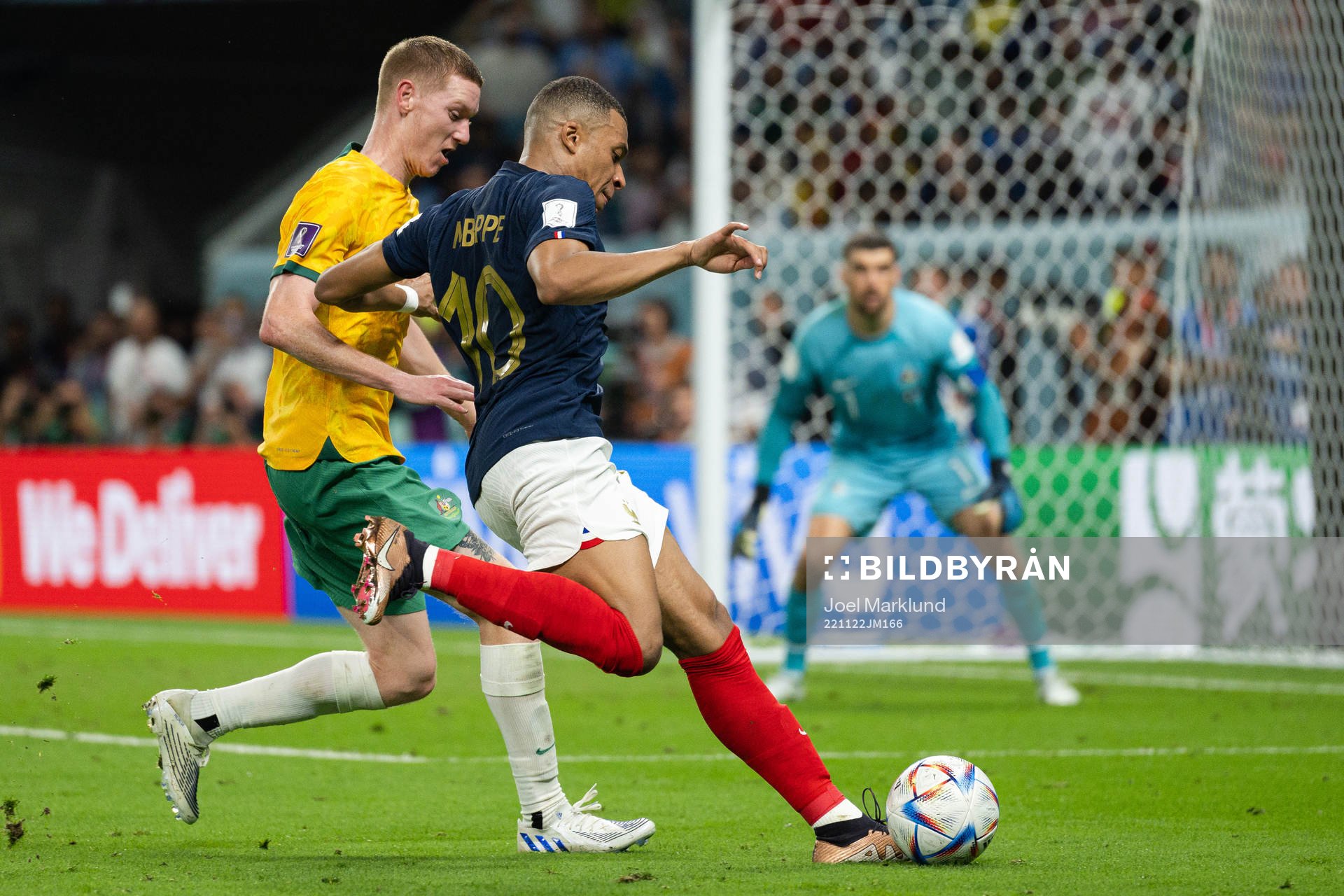 Kye Rowles of Australia and Kylian Mbappe of France