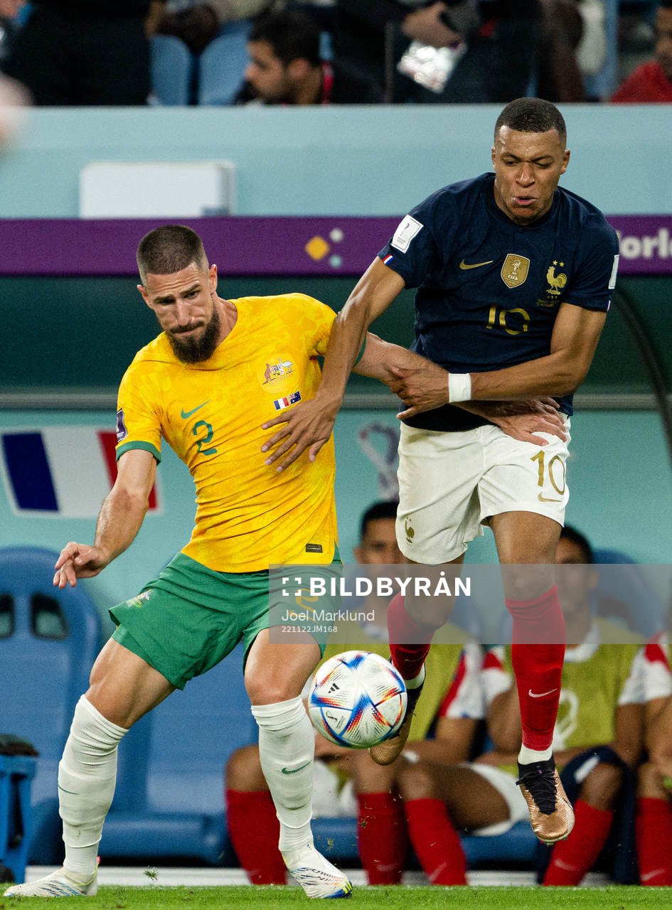 Milos Degenek of Australia and Kylian Mbappe of France