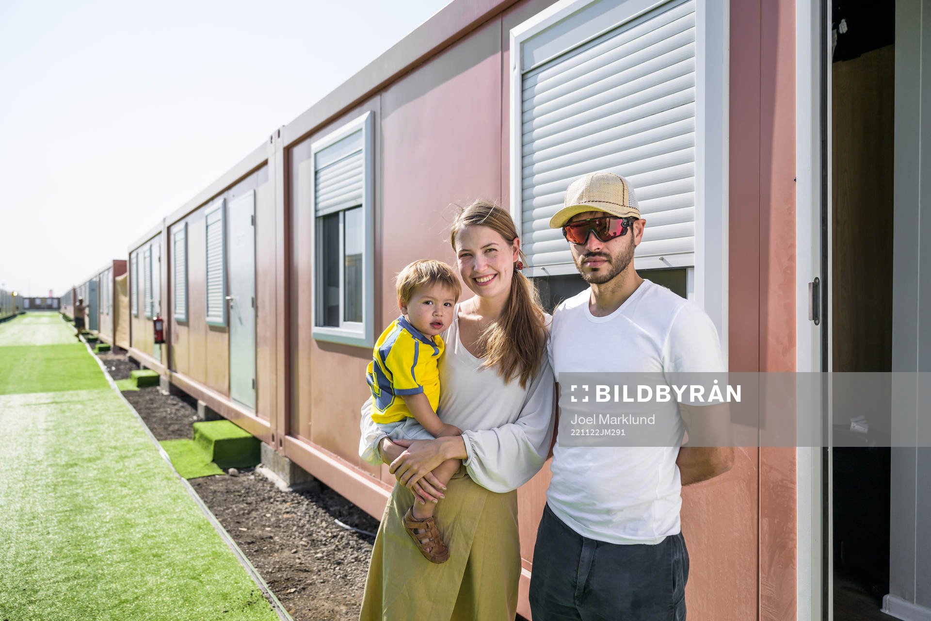 Cecilia Alfsdotter and Juan Pablo pose together with their kid León outside their room at Fan Village Cabins Free Zone during day 3 of the FIFA World Cup 2022 on November 22, 2022 in Doha.