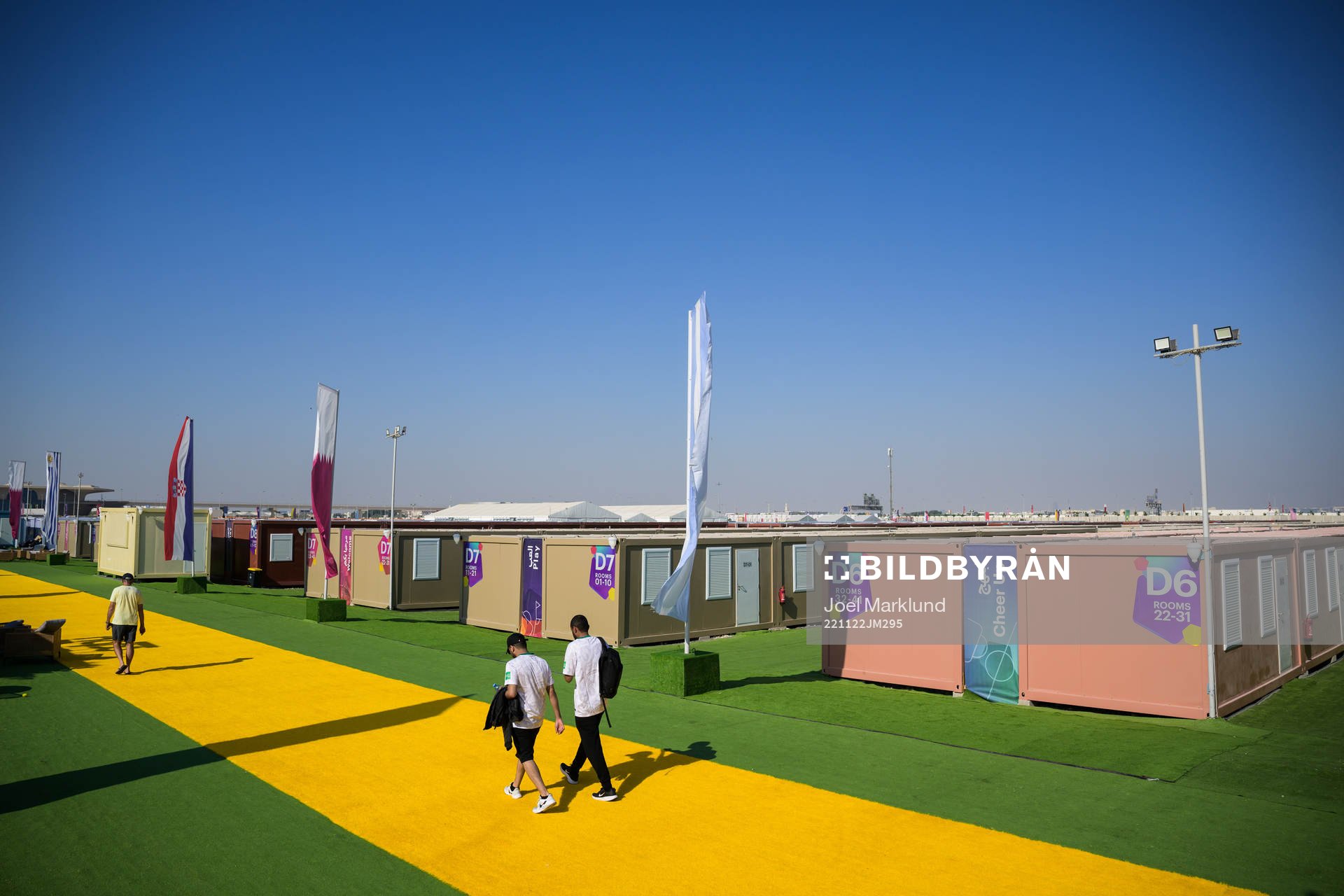 People walk between containers at Fan Village Cabins Free Zone during day 3 of the FIFA World Cup 2022 on November 22, 2022 in Doha.