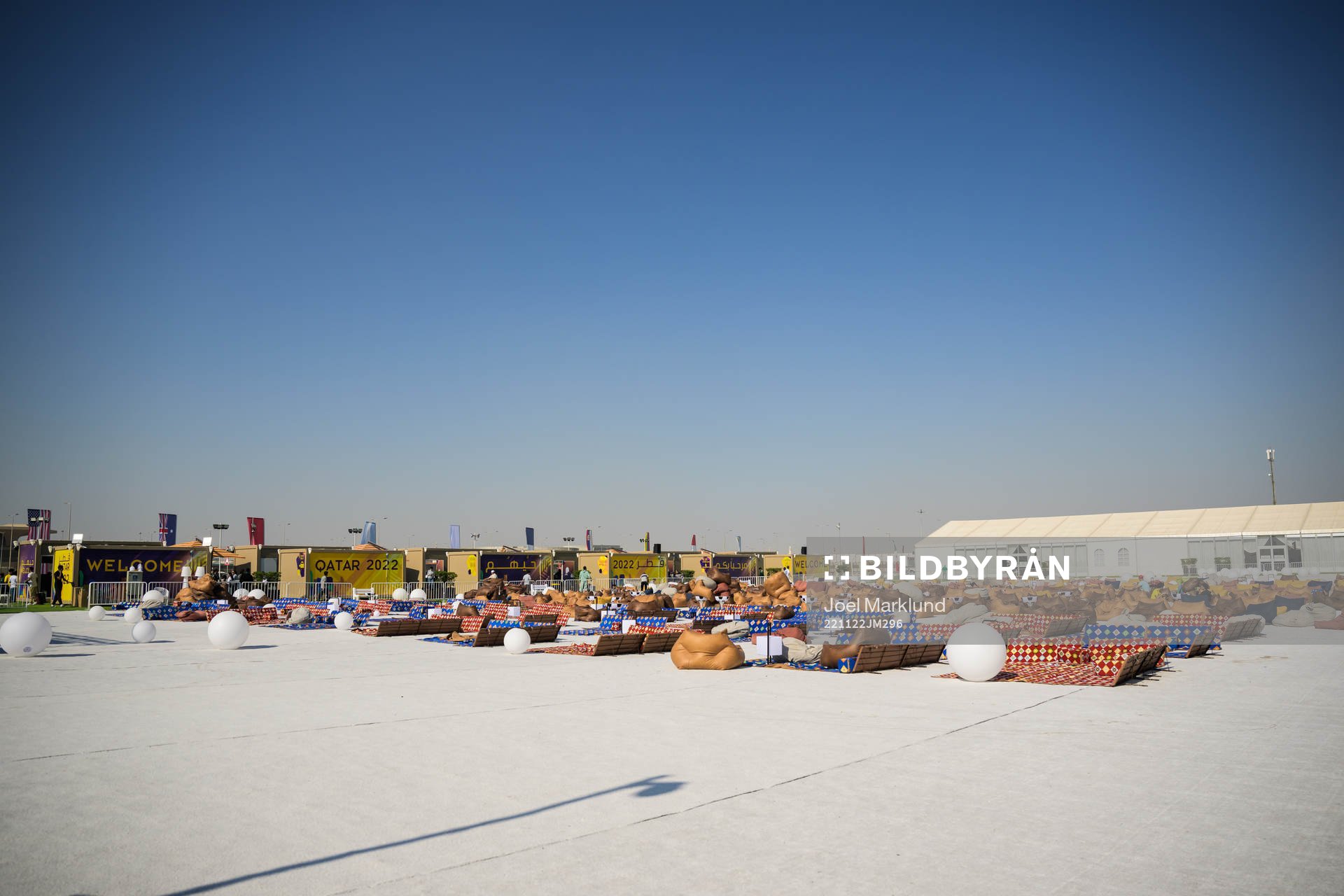 A seating area in front of a big tv screen at Fan Village Cabins Free Zone during day 3 of the FIFA World Cup 2022 on November 22, 2022 in Doha.