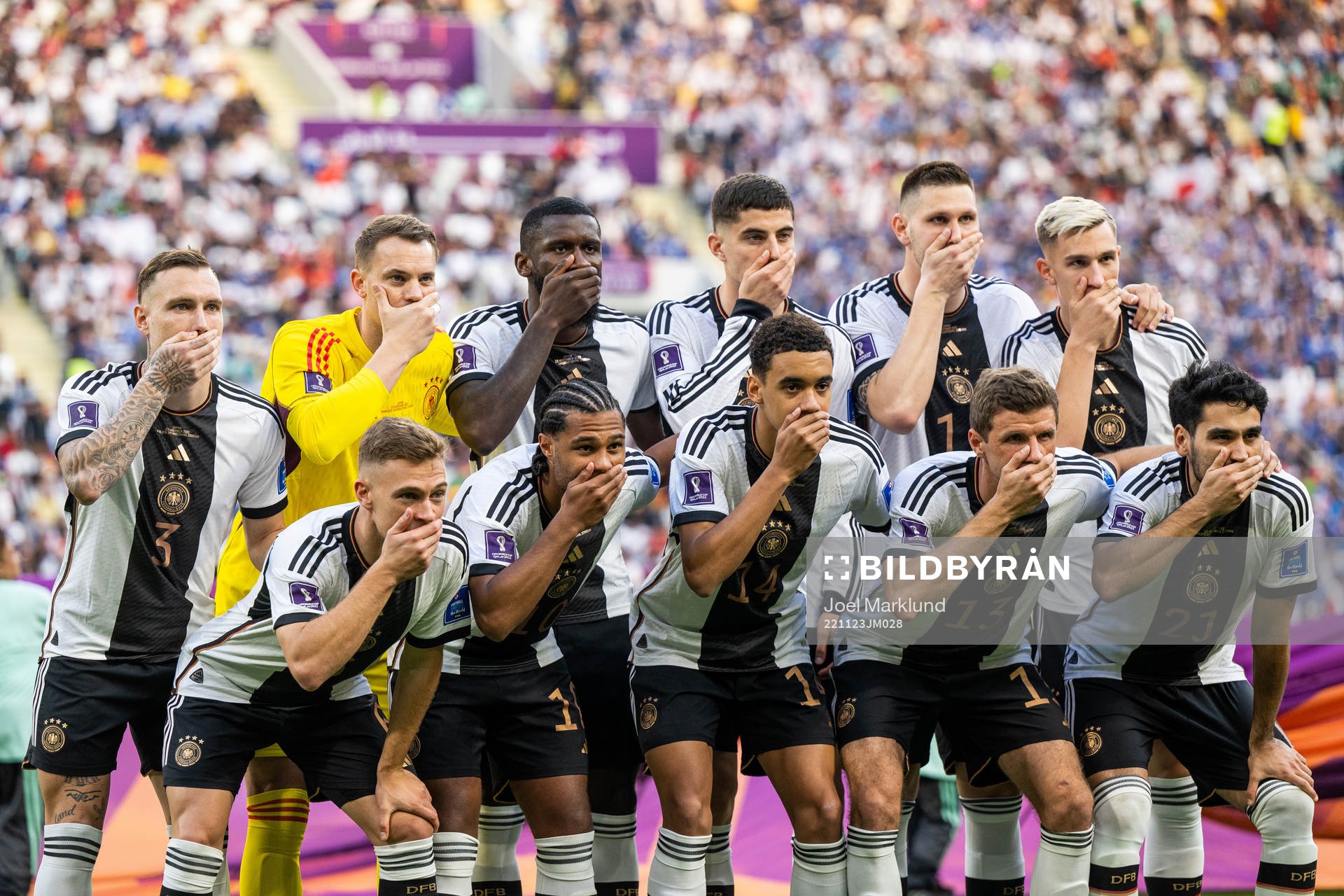 The starting eleven of Germany hold their hands over their mouths in a protest as they pose for a photo ahead of the FIFA World Cup 2022 football match between Germany and Japan on November 23, 2022 in Doha.