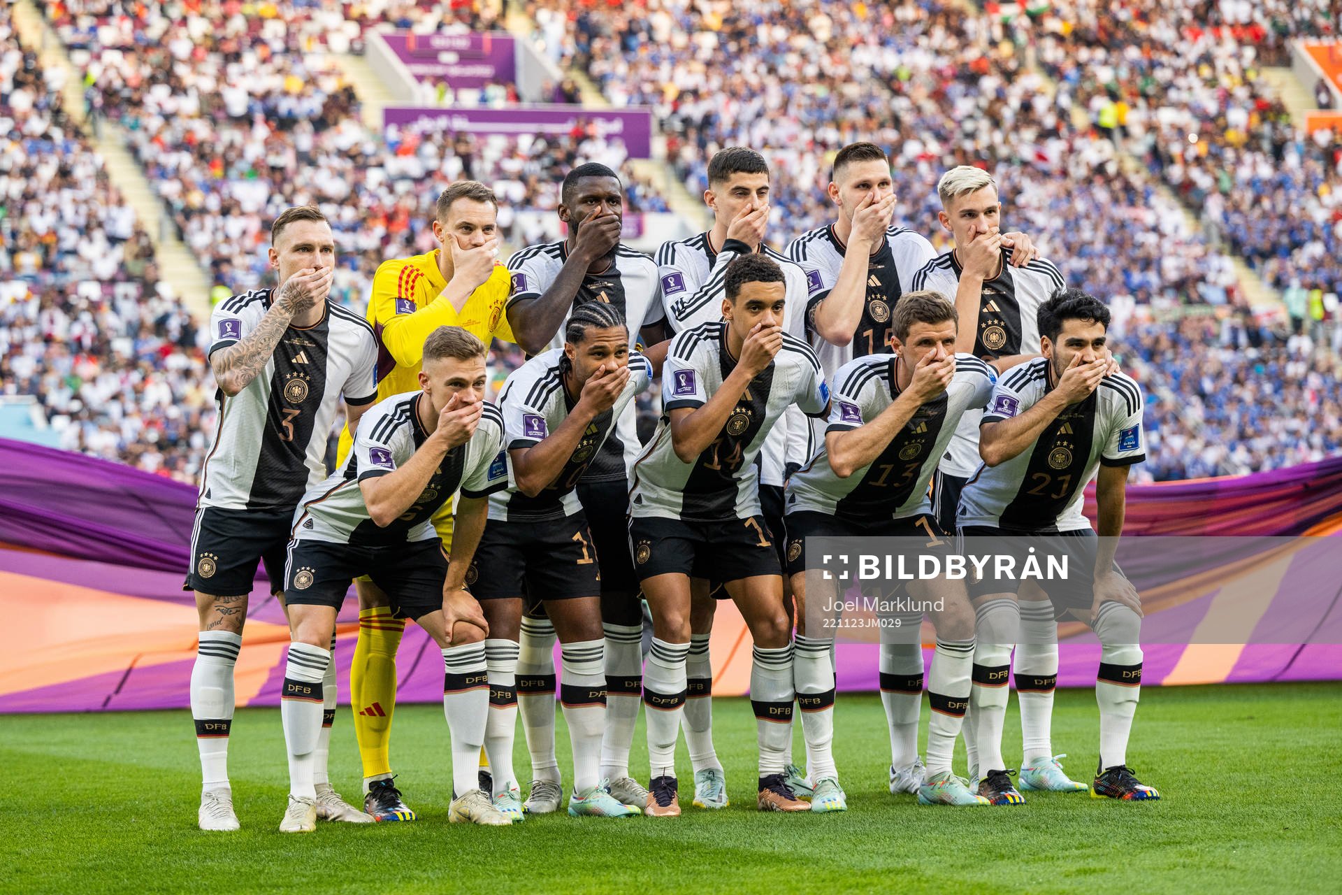 The starting eleven of Germany hold their hands over their mouths in a protest as they pose for a photo ahead of the FIFA World Cup 2022 football match between Germany and Japan on November 23, 2022 in Doha. 