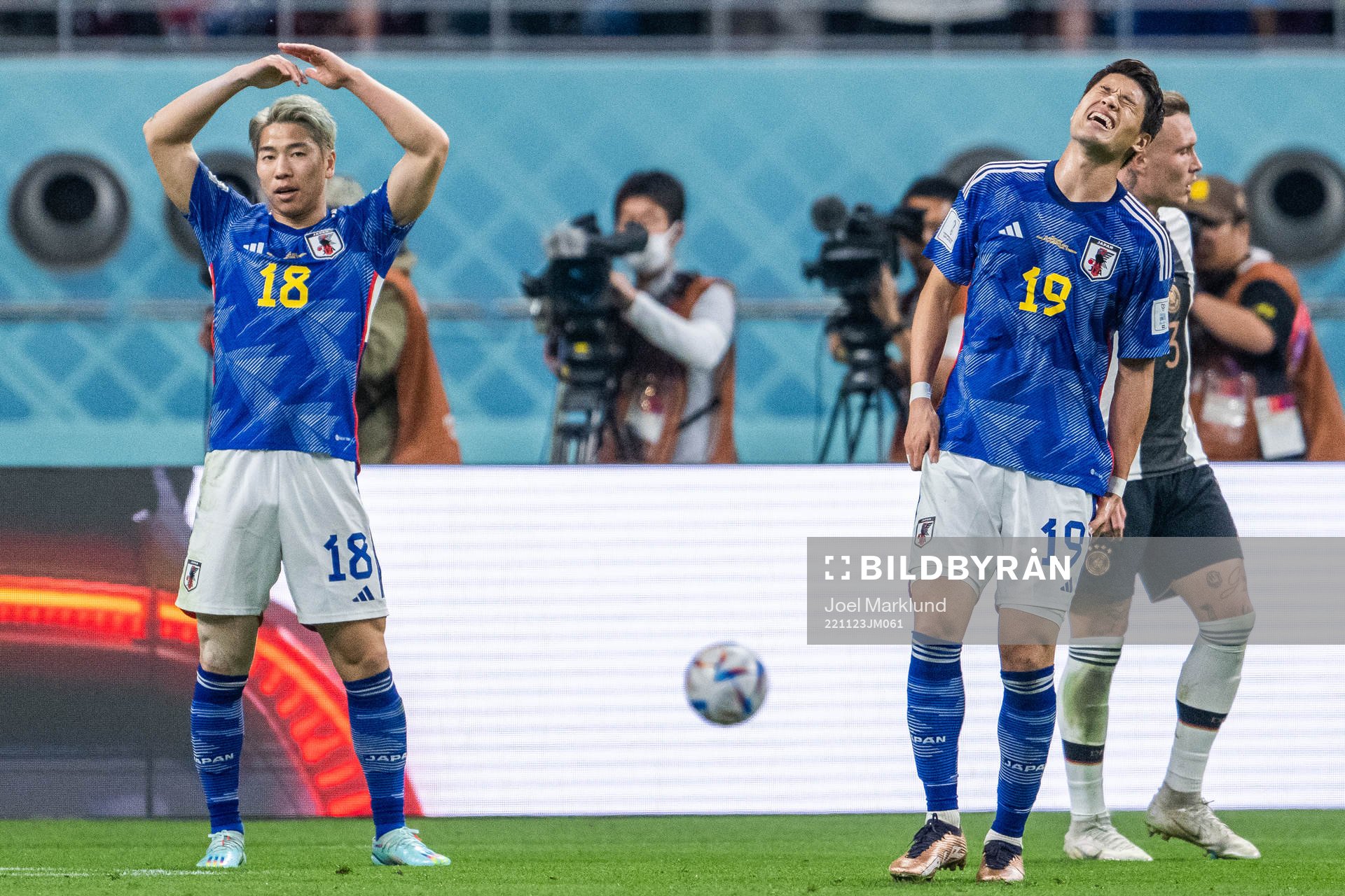 Takuma Asano and Hiroki Sakai of Japan look dejected