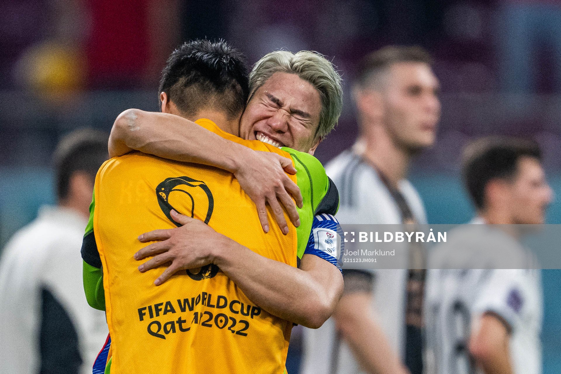Takuma Asano of Japan celebrates with a team mate