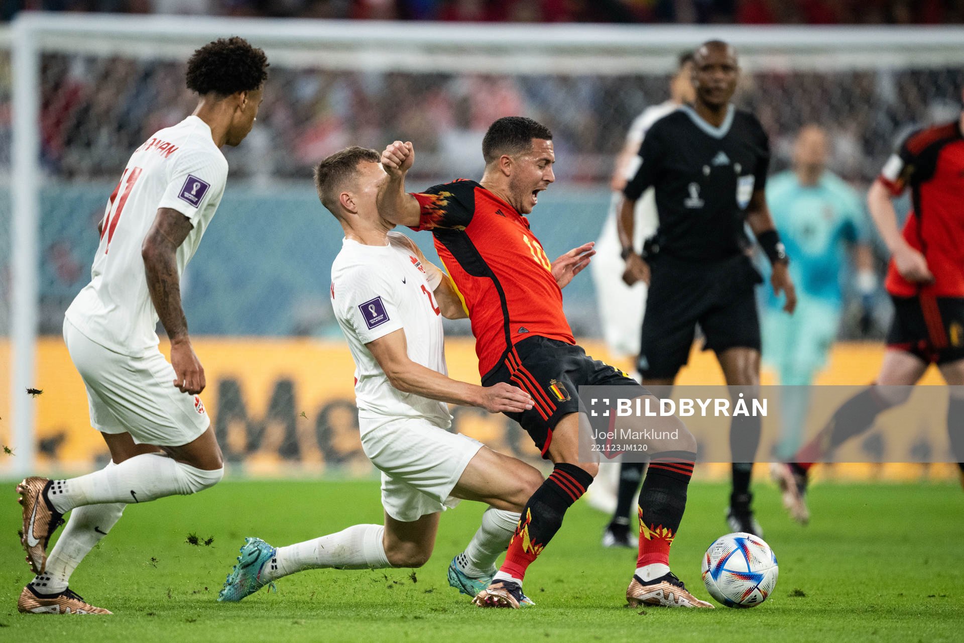 Alistair Johnston of Canada and Eden Hazard of Belgium
