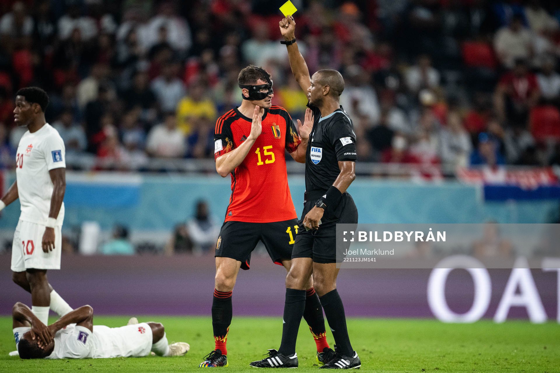 Thomas Meunier of Belgium receives a yellow card from
