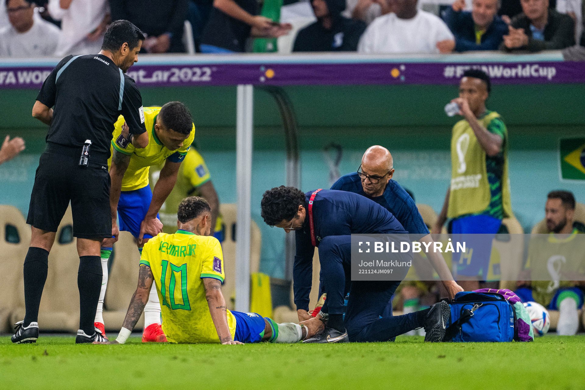 Neymar of Brazil receives medical attention