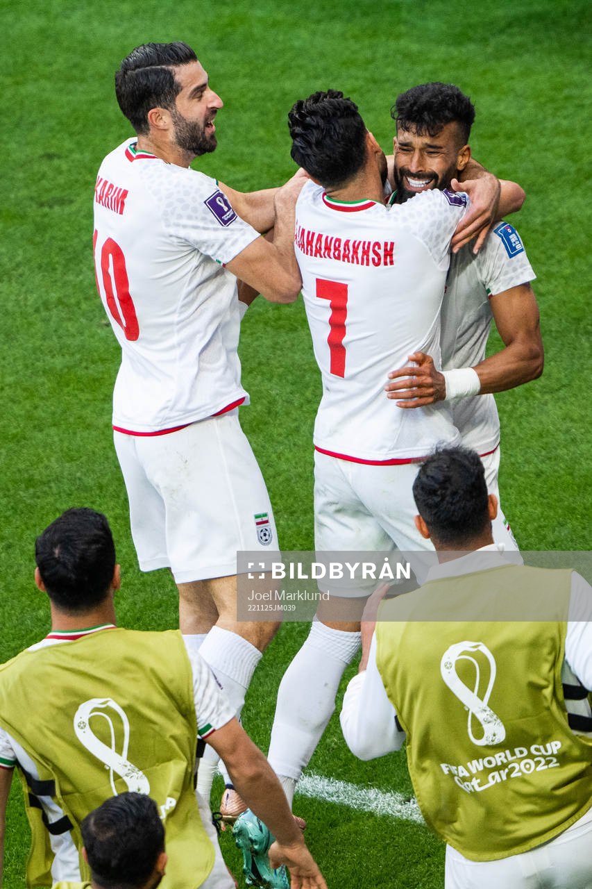 Ramin Rezaeian of Iran celebrates with Karim Ansarifard and