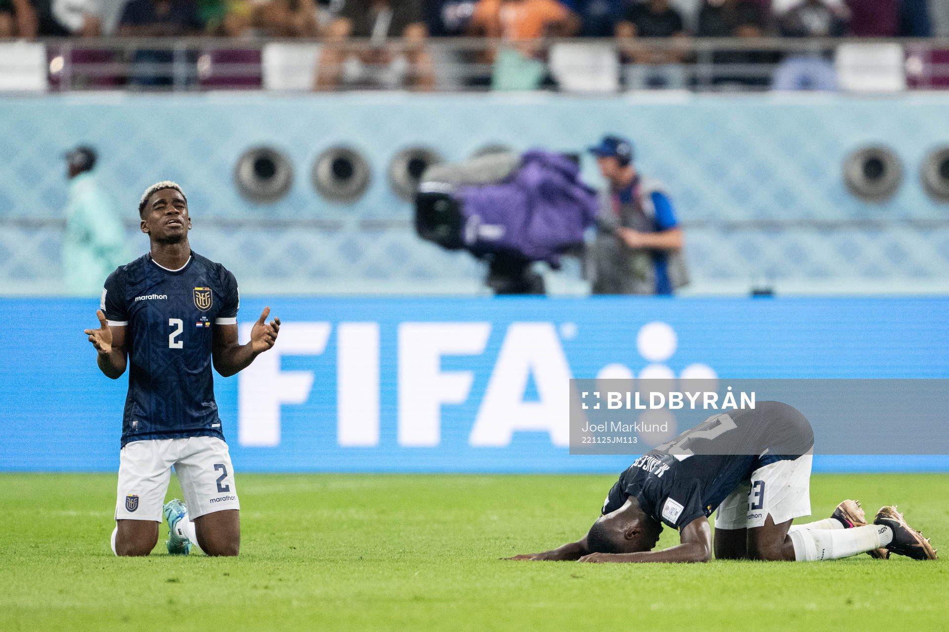Felix Torres and Moises Caicedo of Ecuador pray