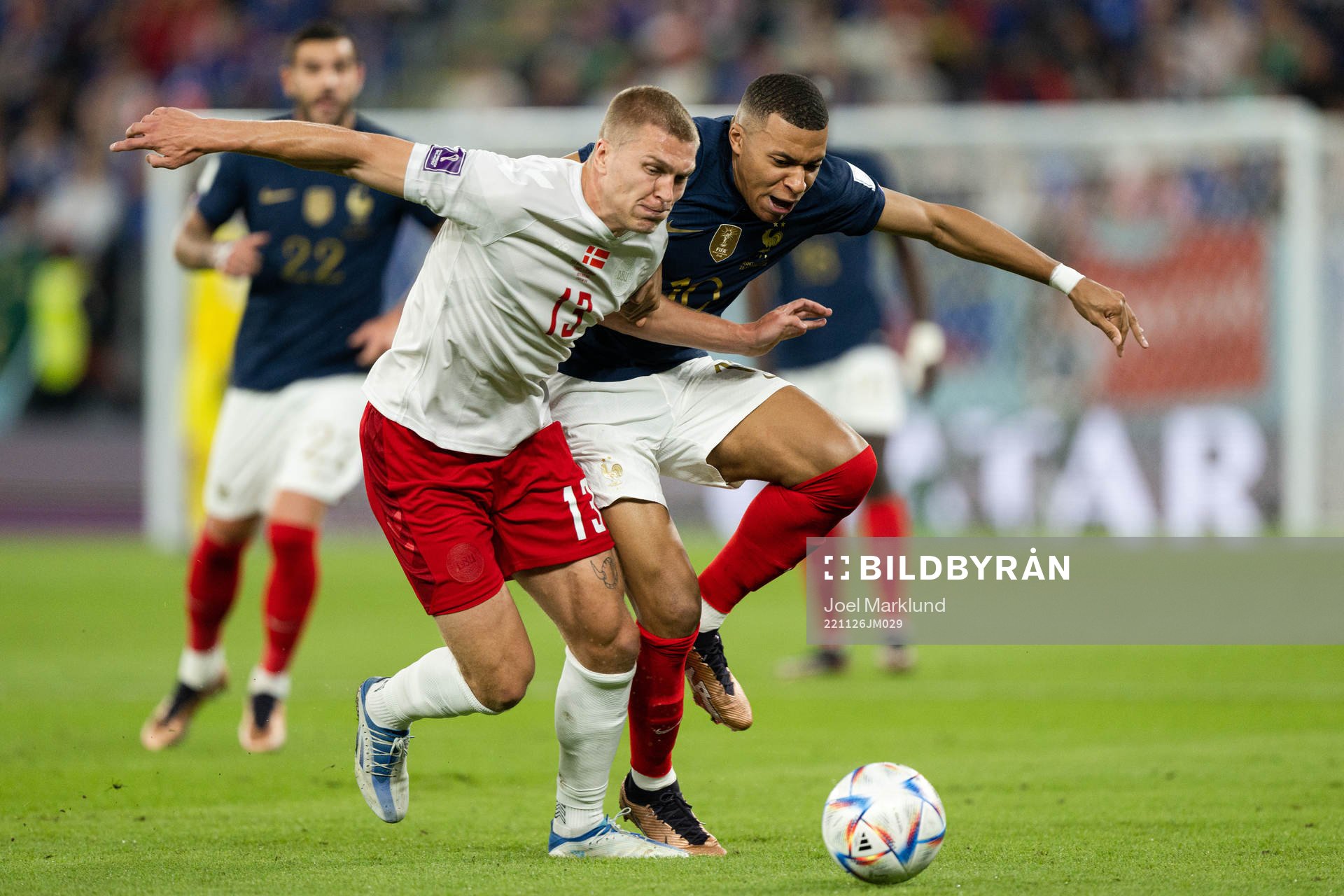Rasmus Kristensen of Denmark and Kylian Mbappe of France