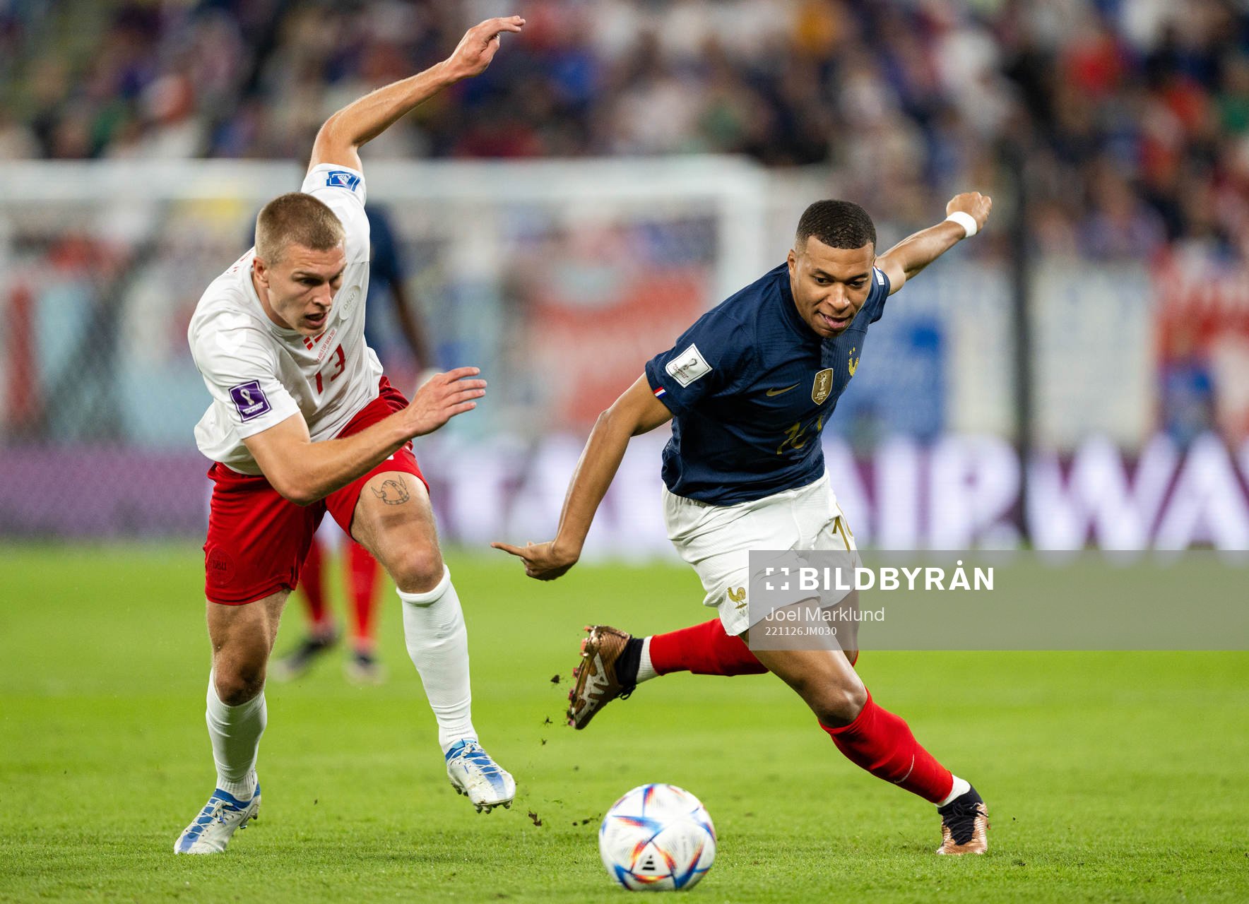 Rasmus Kristensen of Denmark and Kylian Mbappe of France