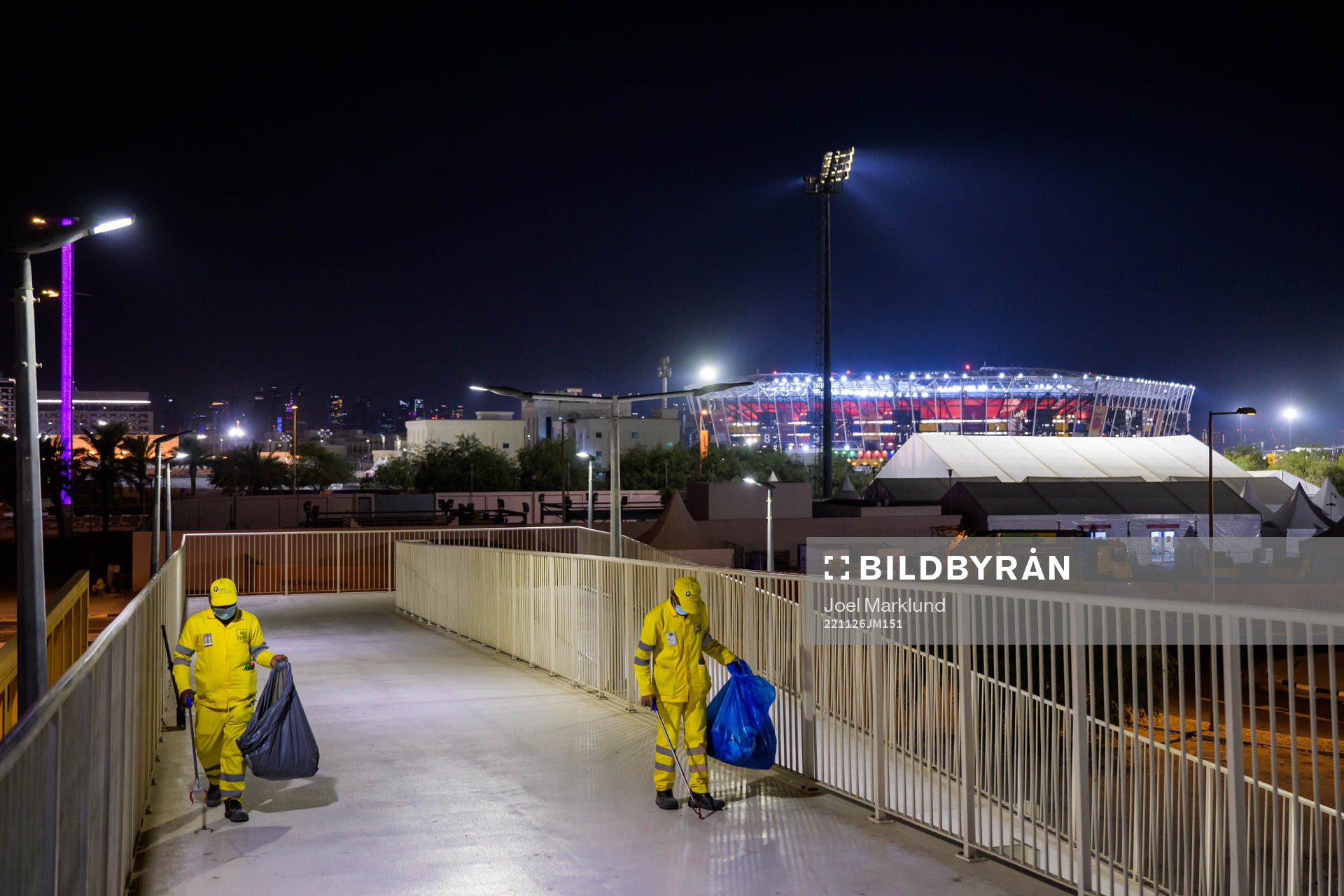 Stadium 974 is seen in the background as migrant workers