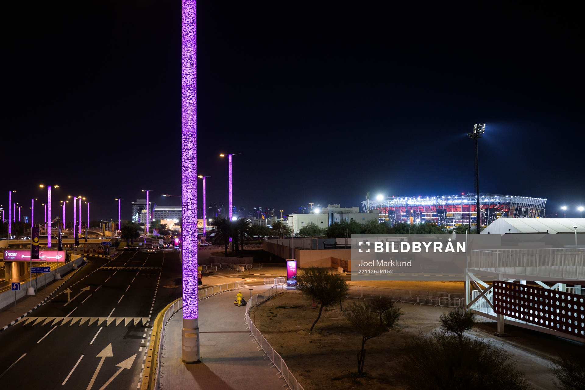 Stadium 974 is seen in the background as a migrant worker