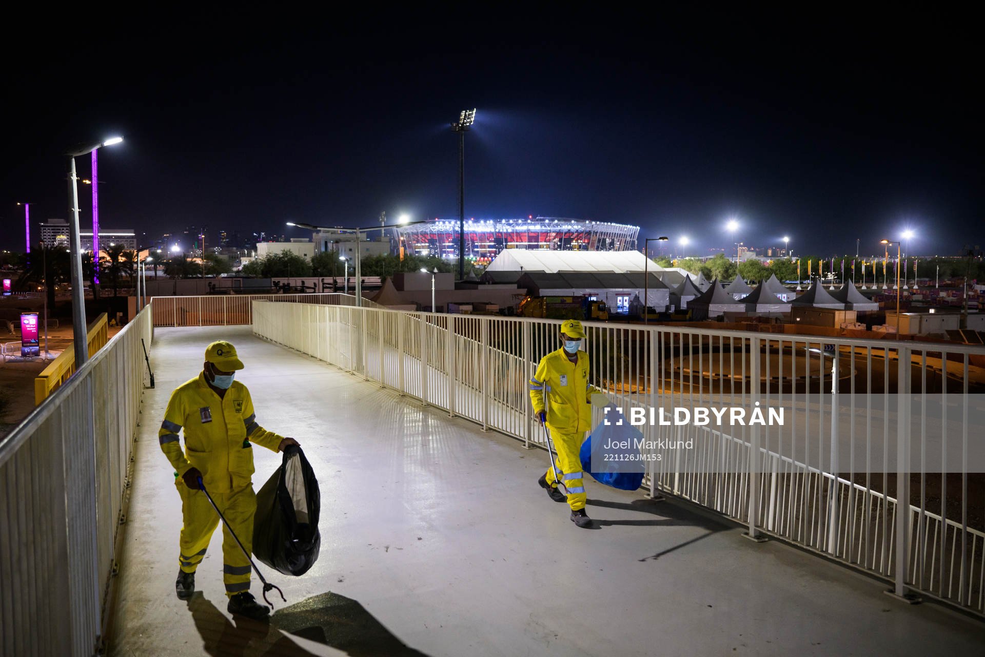 Stadium 974 is seen in the background as migrant workers