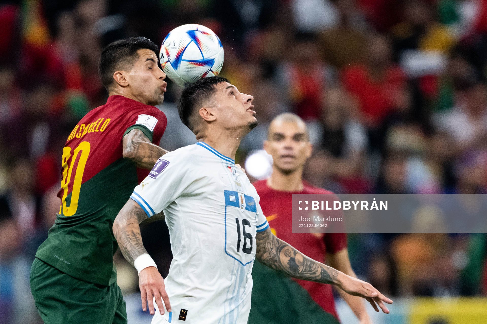 Joao Cancelo of Portugal and Mathias Olivera of Uruguay