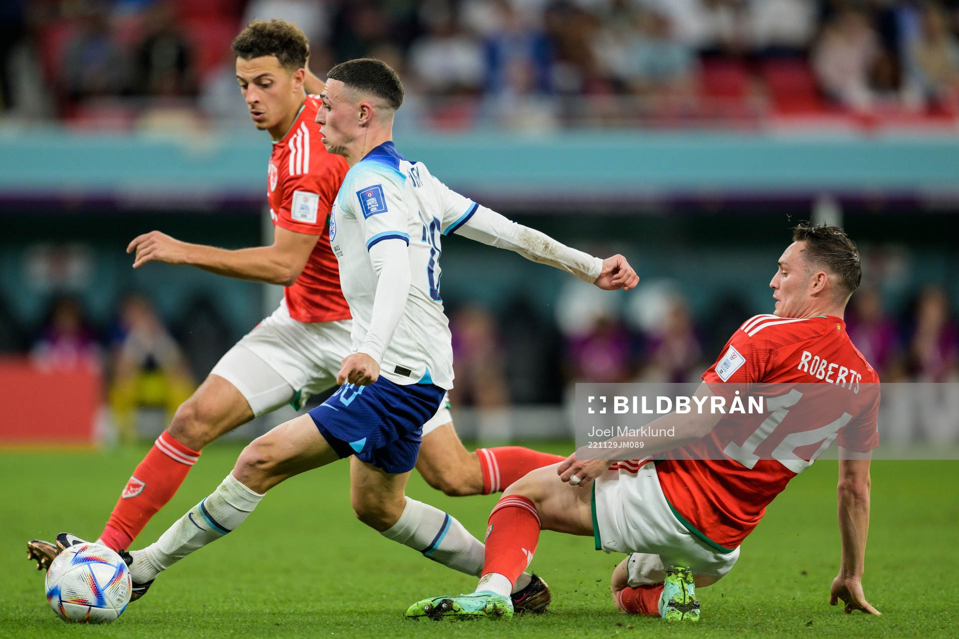 Ethan Ampadu and Connor Roberts of Wales against Phil Foden of England during the FIFA World Cup 2022 football match between Wales and England on November 29, 2022 in Doha.