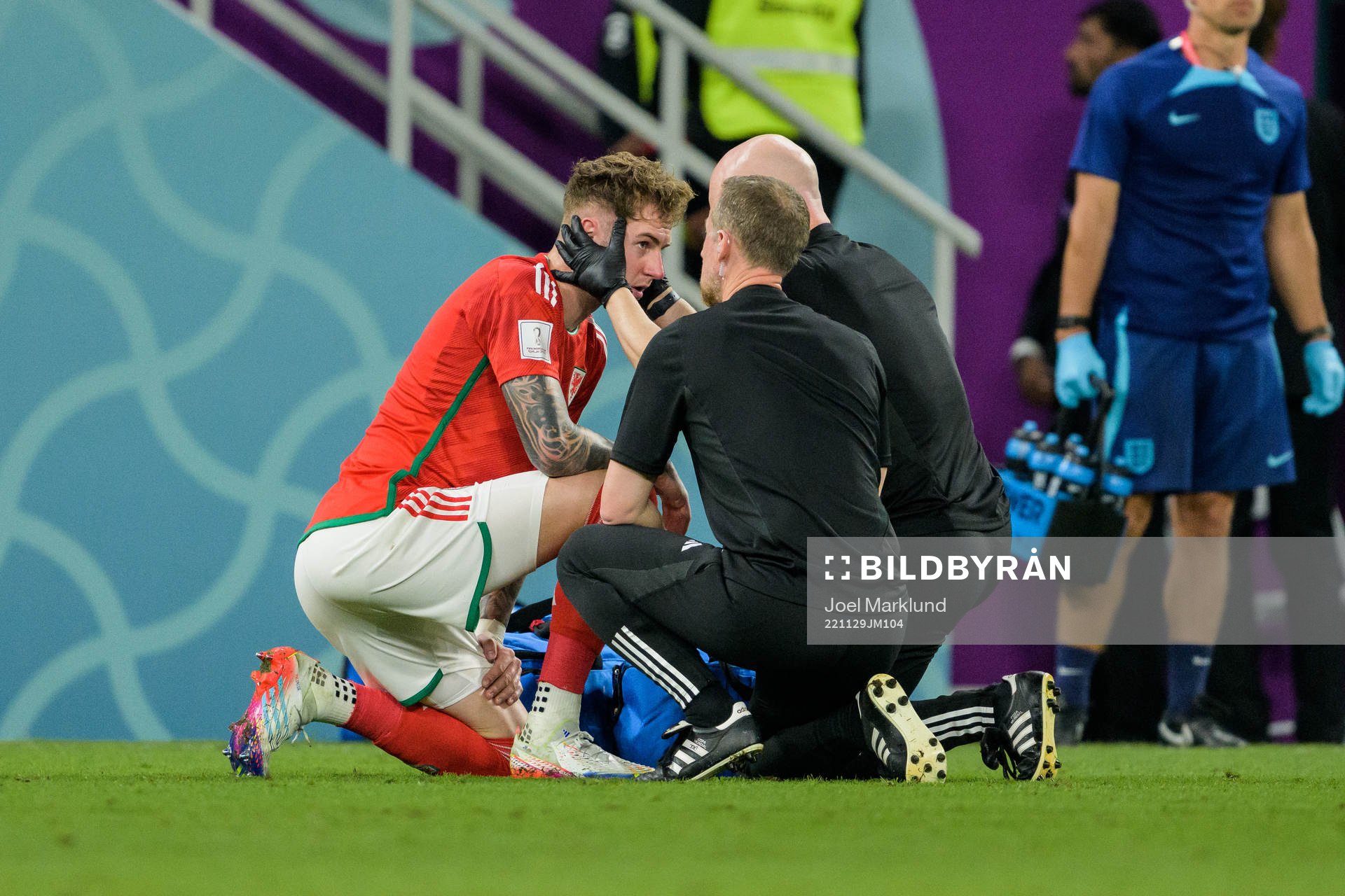 Joe Rodon of Wales recieves medical attention