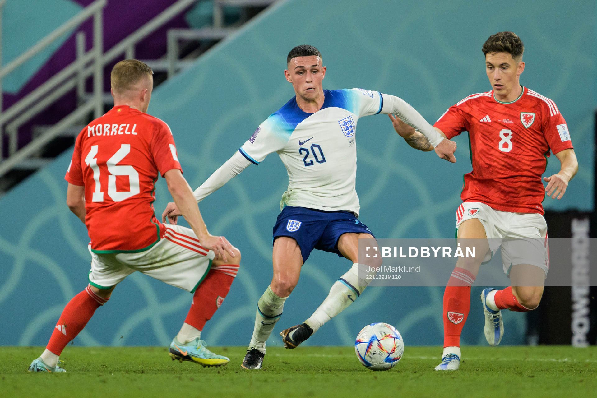 Joe Morrell and Harry Wilson of Wales against Phil Foden of