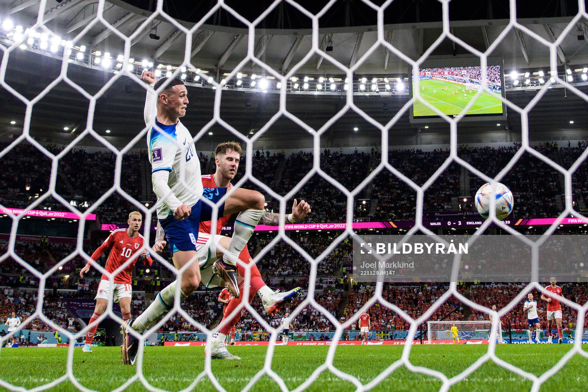 Phil Foden of England challenges Joe Rodon of Wales during the FIFA World Cup 2022 football match between Wales and England on November 29, 2022 in Doha.